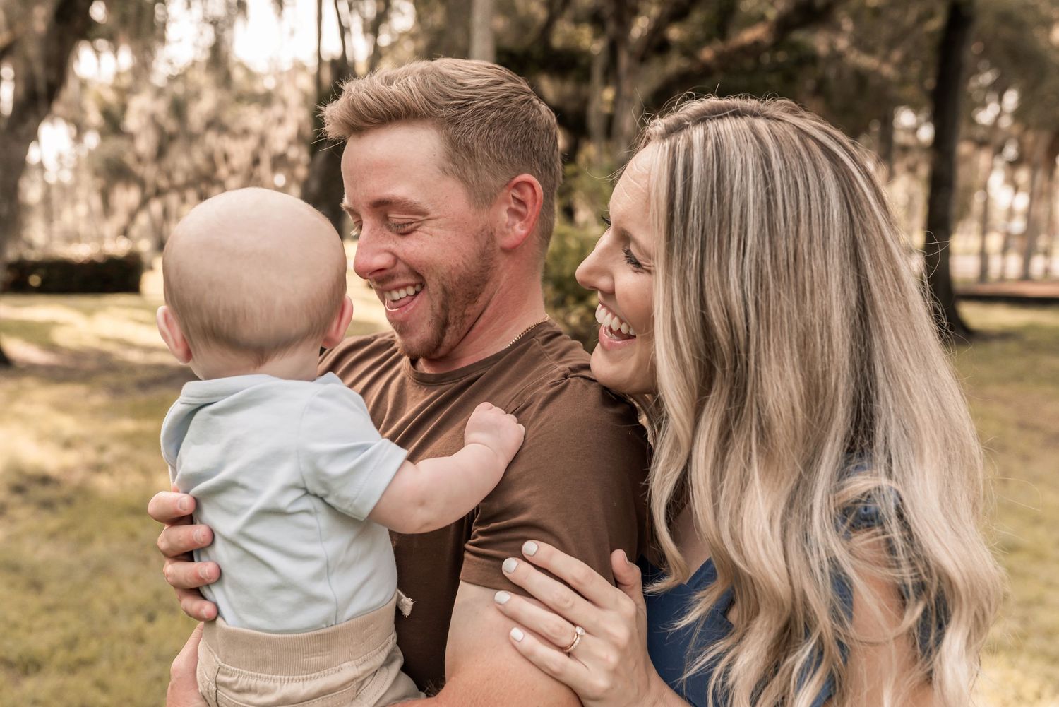 A loving family shares tender moments together in a series of candid outdoor photographs.