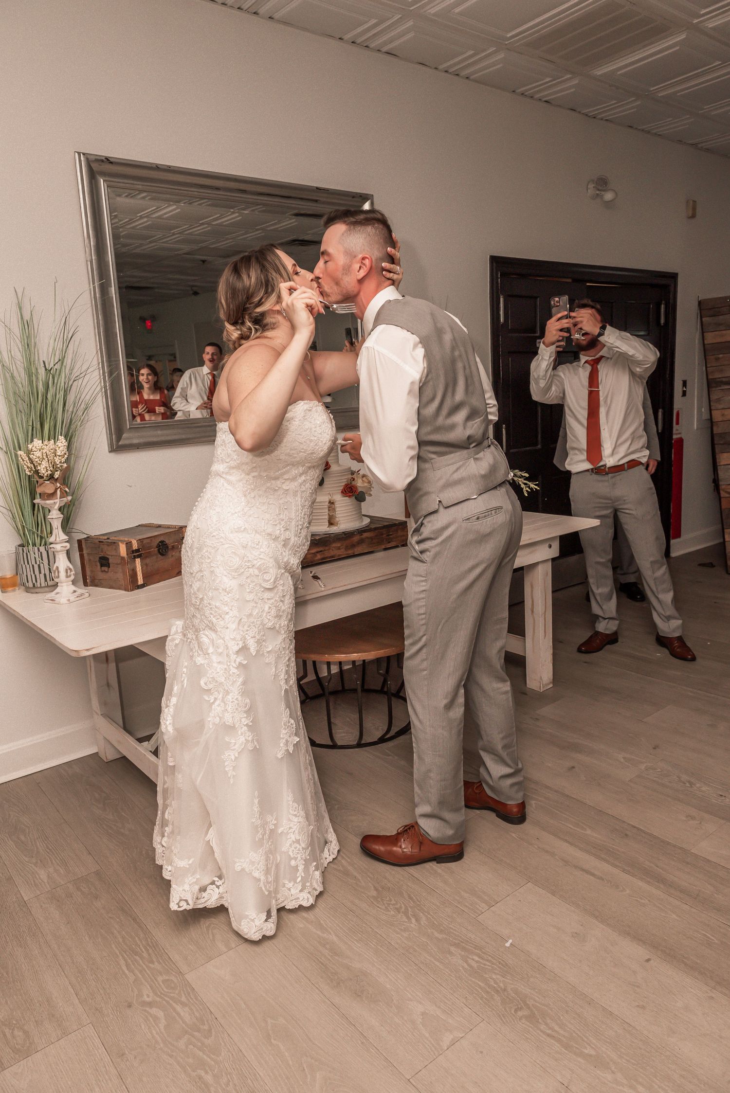 Wedding couple sharing a sweet moment while eating cake together at their reception.