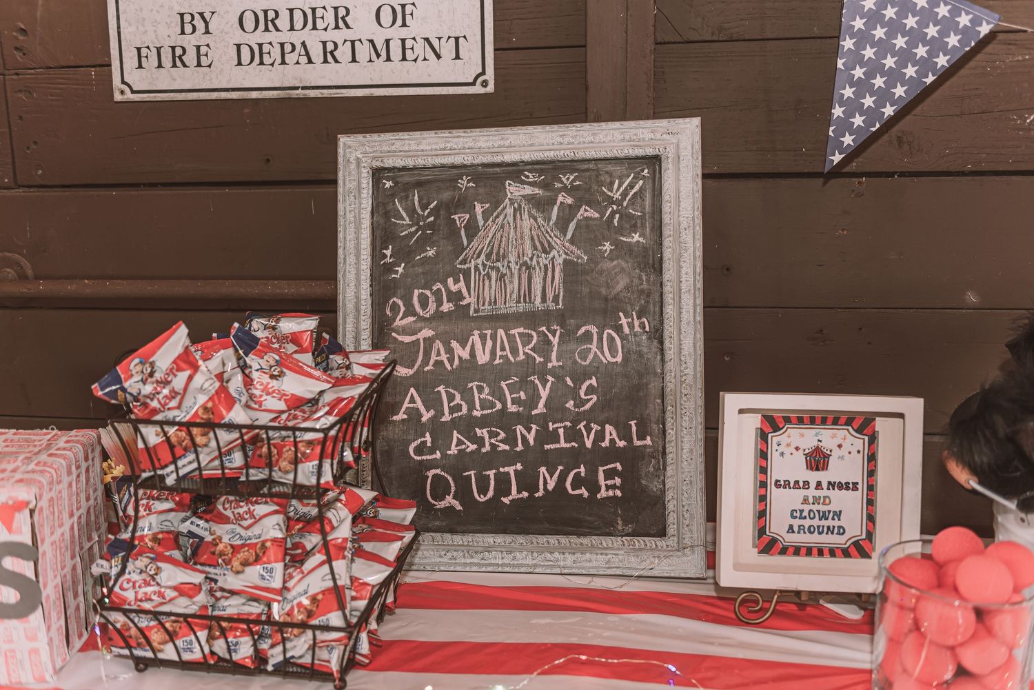 Chalkboard sign and candy display at a graduation party with red decor and bunting.
