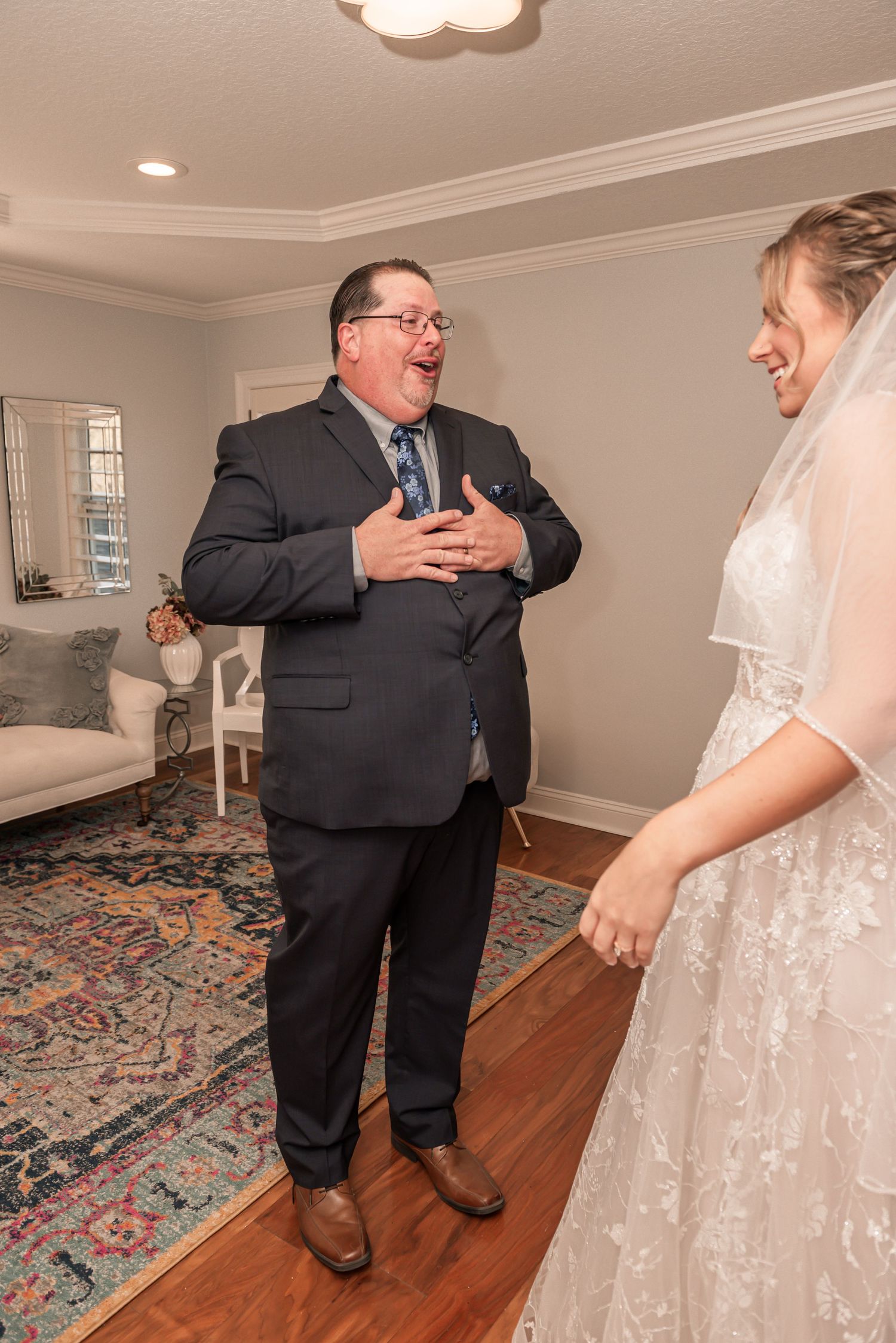 A heartwarming moment shared between two people during a wedding celebration in a cozy home interior.