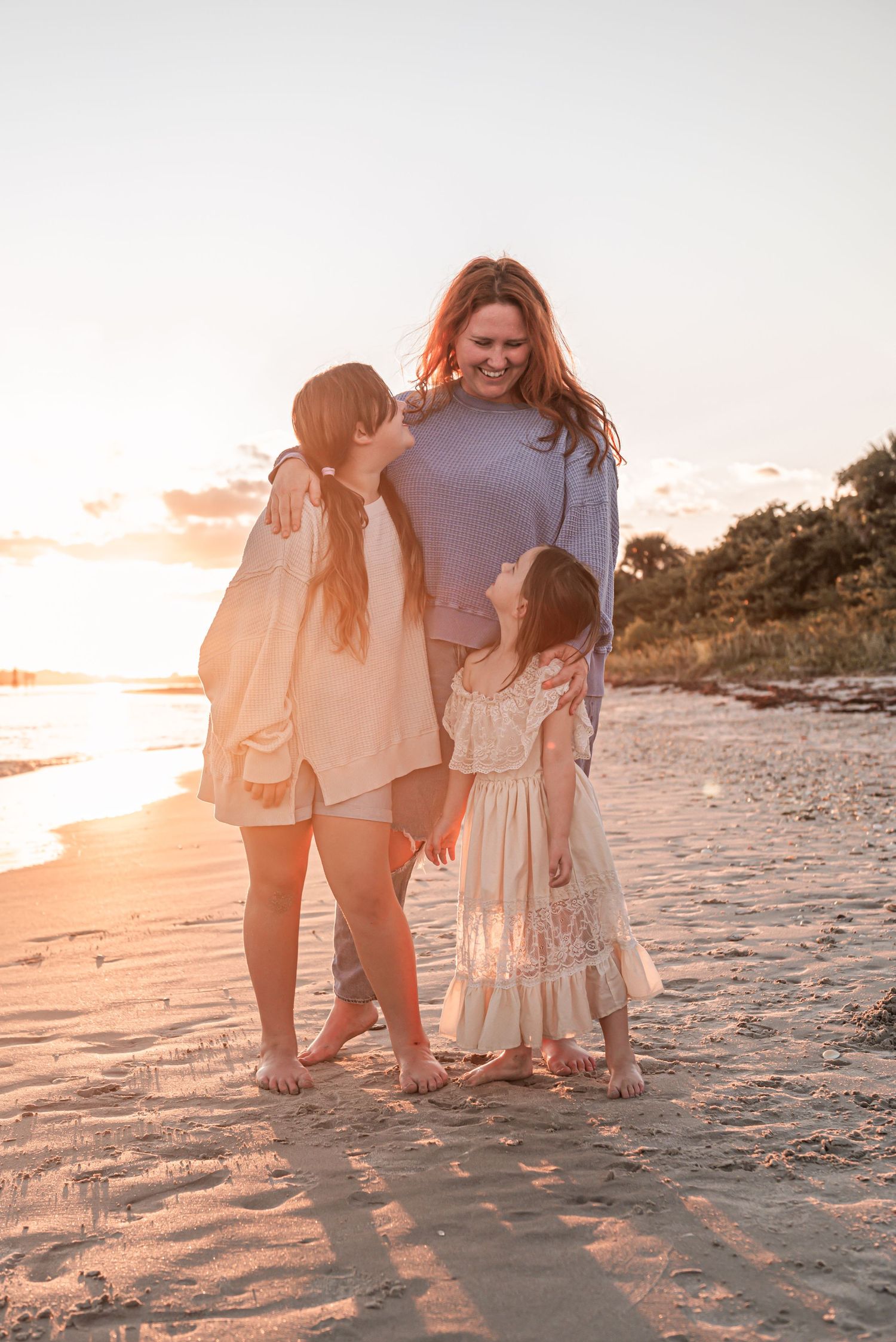 Three images show people walking along a sandy beach at sunset casting long shadows in warm golden light.