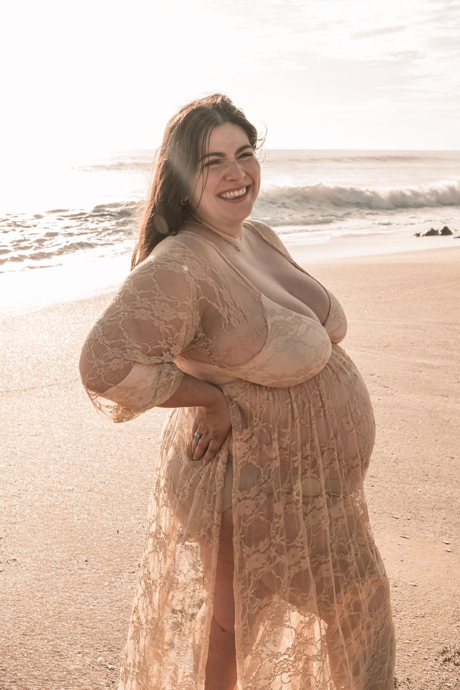 Beachside portrait series with someone twirling in a flowing lace dress at sunset, creating ethereal movement.
