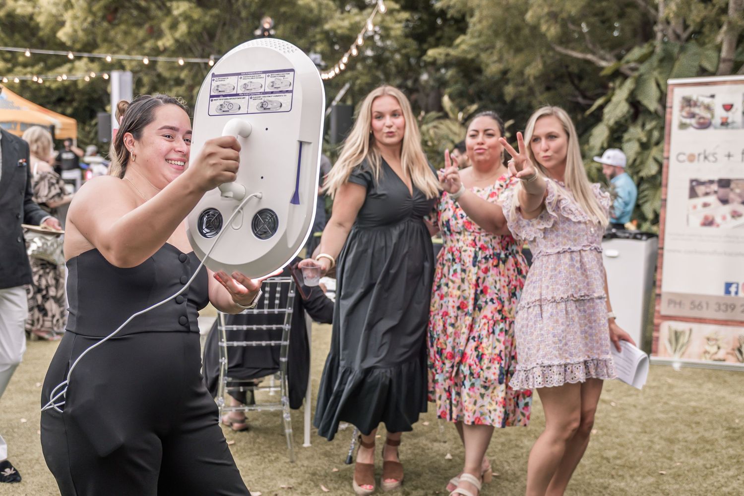 Wedding guests celebrate and dance together at an outdoor reception during golden hour.