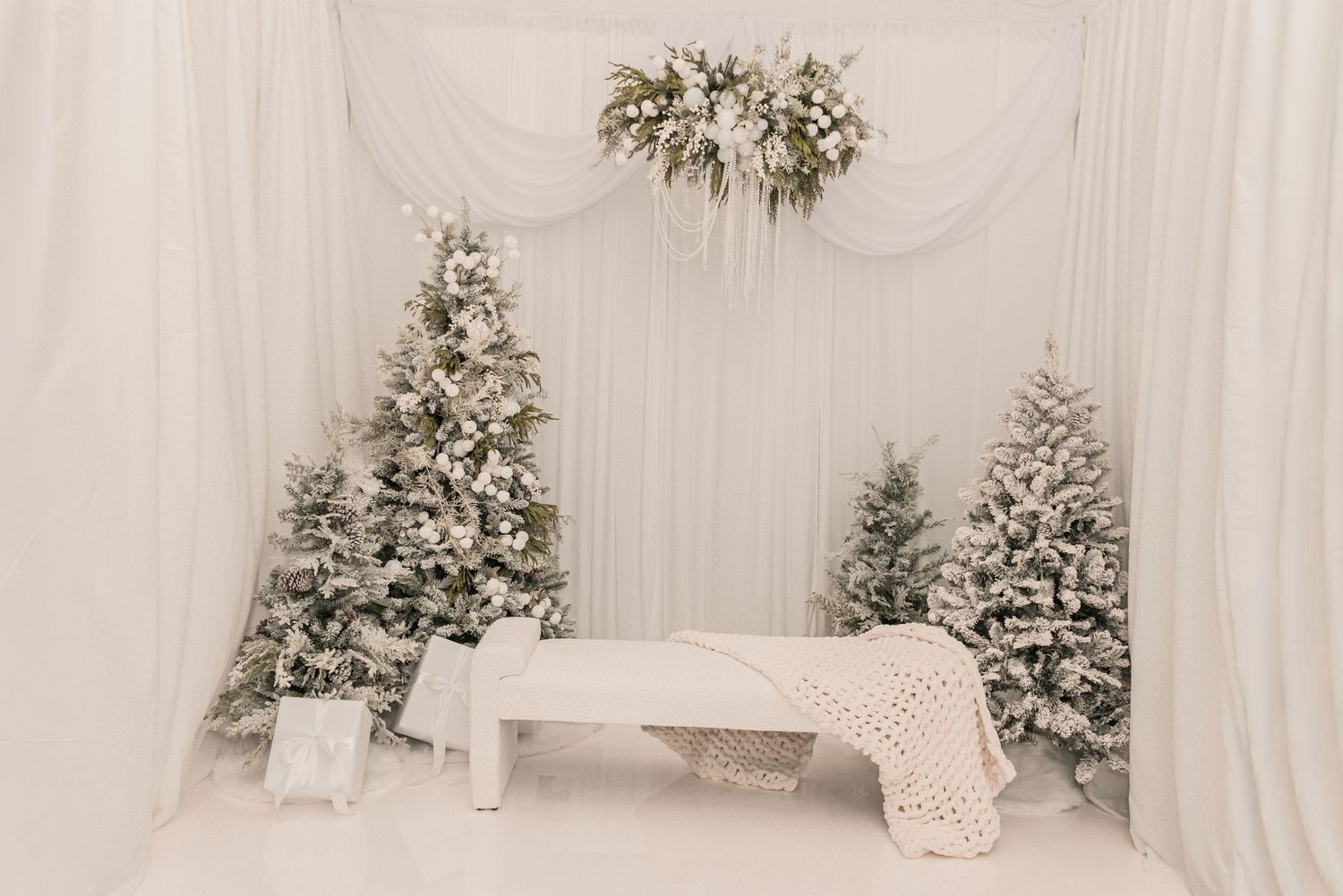 White floral arrangements and decor create an elegant winter wonderland wedding reception setting.