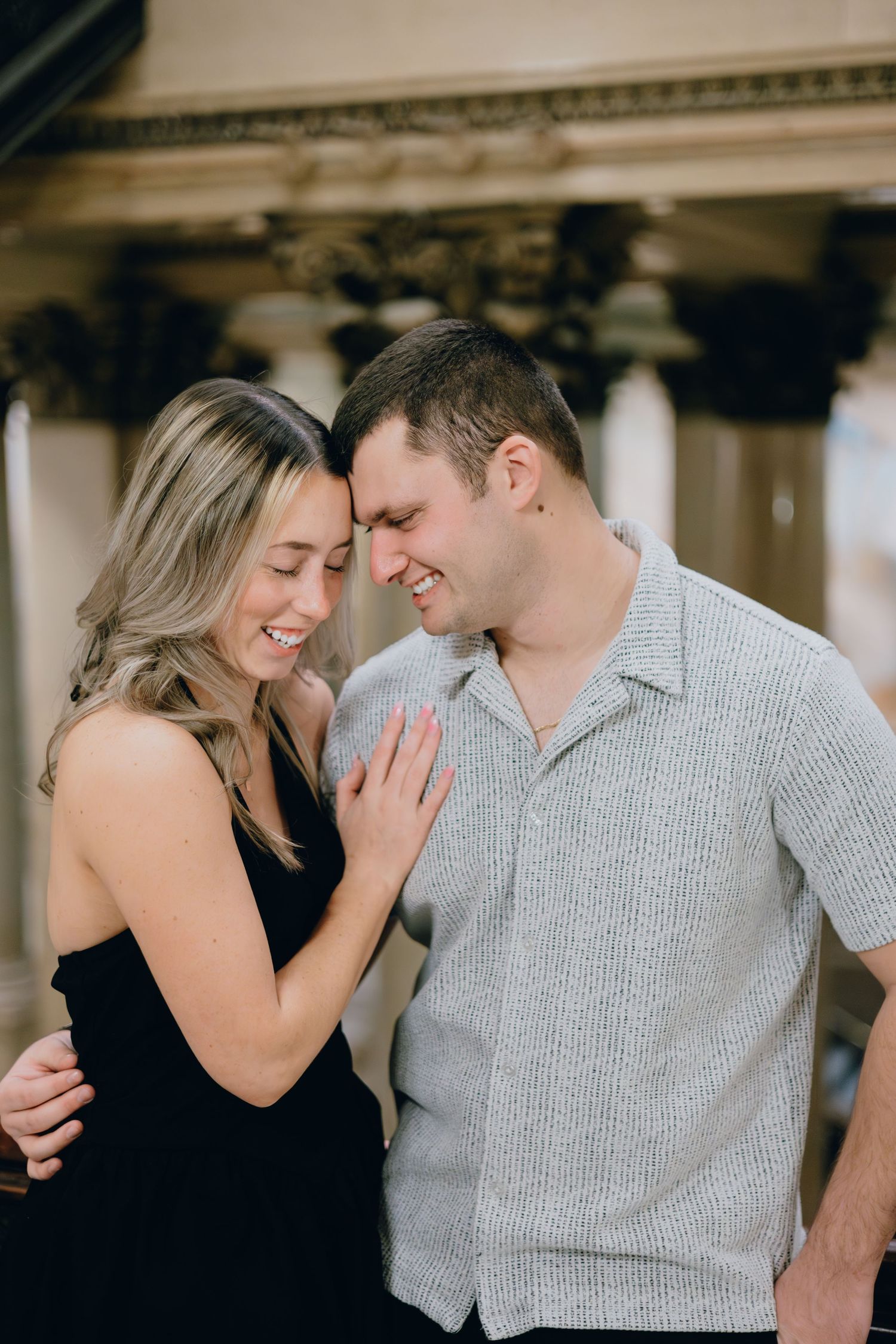 Intimate moment captured of couple sharing close embrace and laughter.