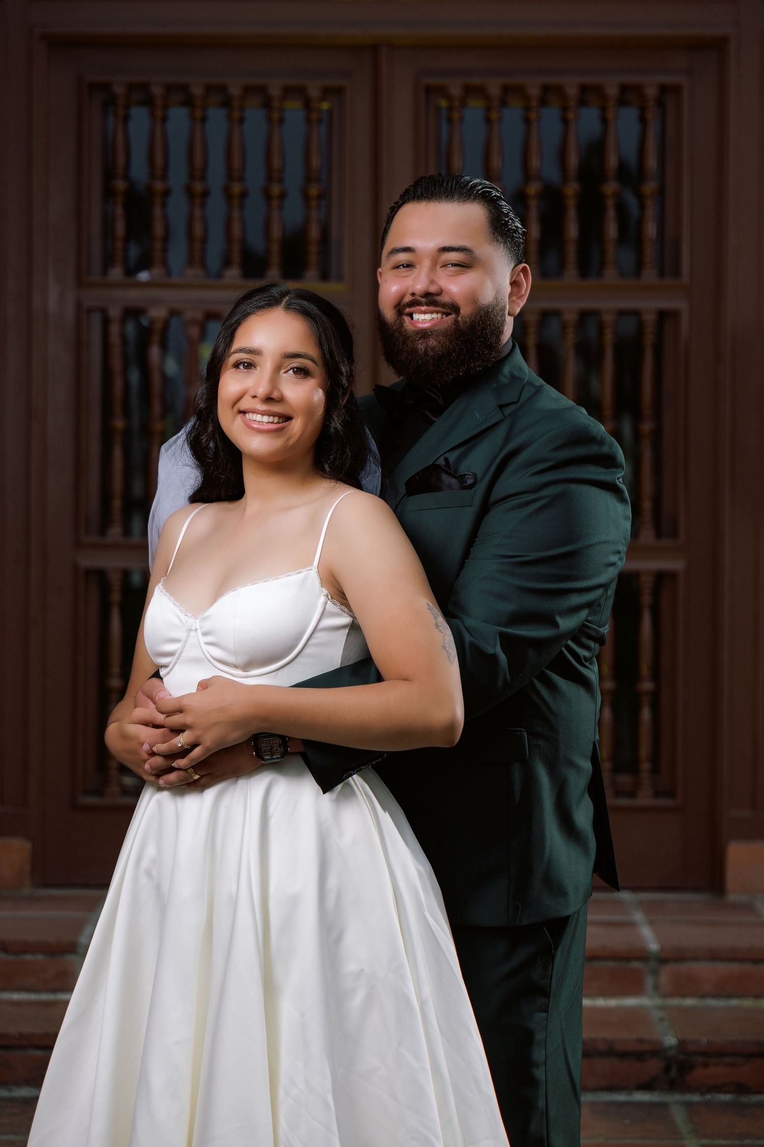 A joyful wedding photoshoot featuring intimate poses against a wooden lattice backdrop.