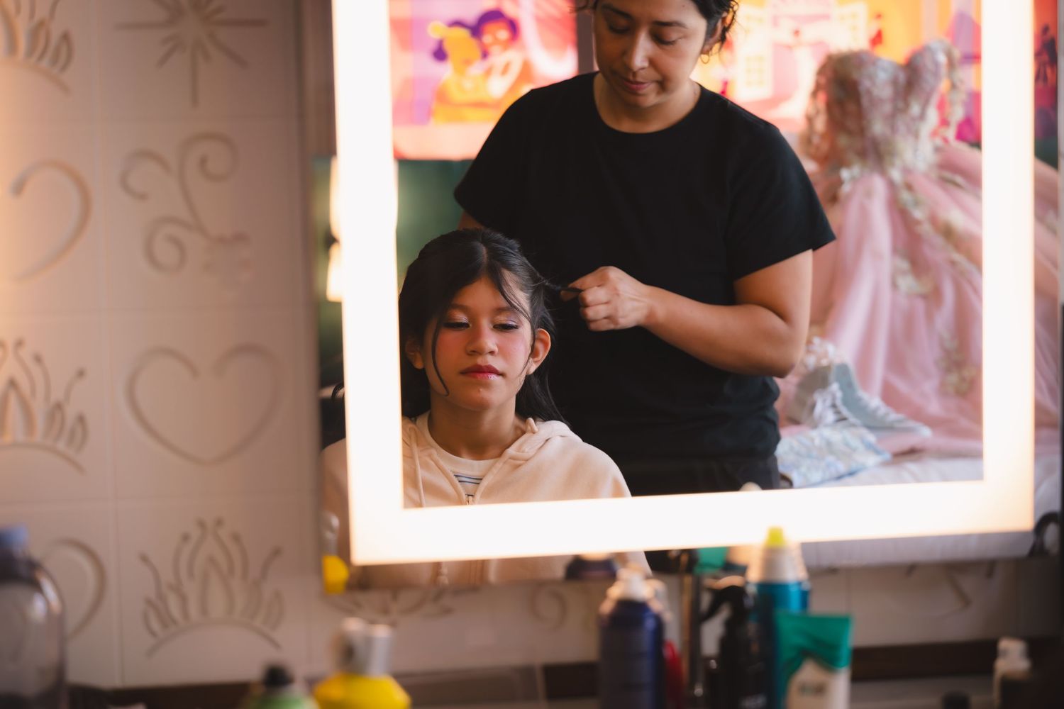 Behind-the-scenes preparation at a beauty salon with styling tools and decorative wall art.