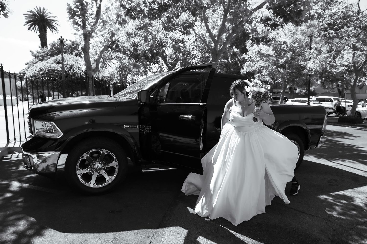 Black and white wedding photo sequence showing bride in flowing dress posing with classic car outdoors.
