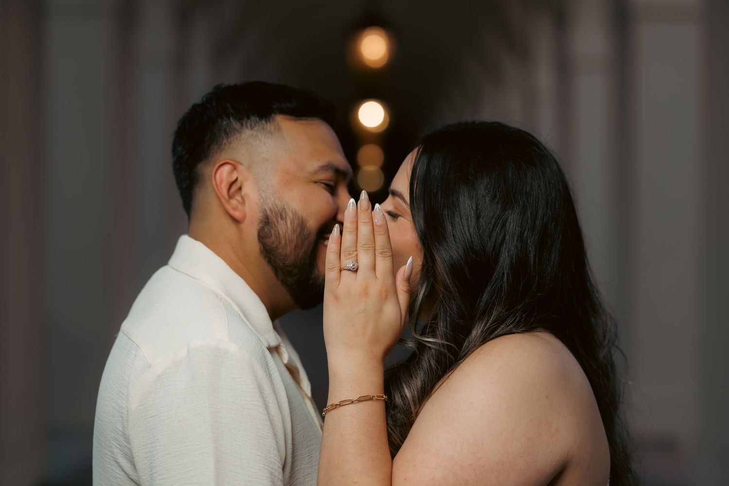 Intimate wedding portraits captured in dramatic lighting against a neutral background.