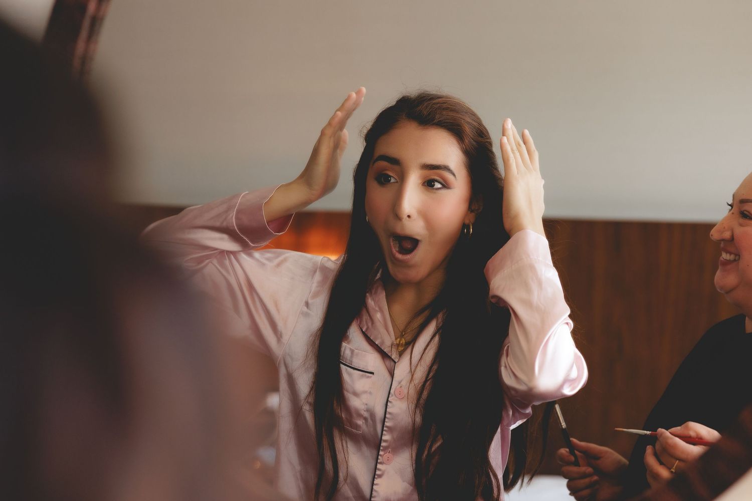 A sequence of photos showing a woman reacting with surprise and excitement while looking at her phone.