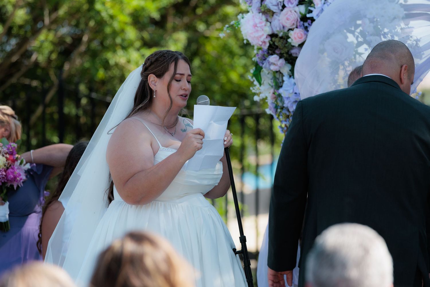 A wedding ceremony collage showing five candid moments of a bride and groom under floral arches and decorations.