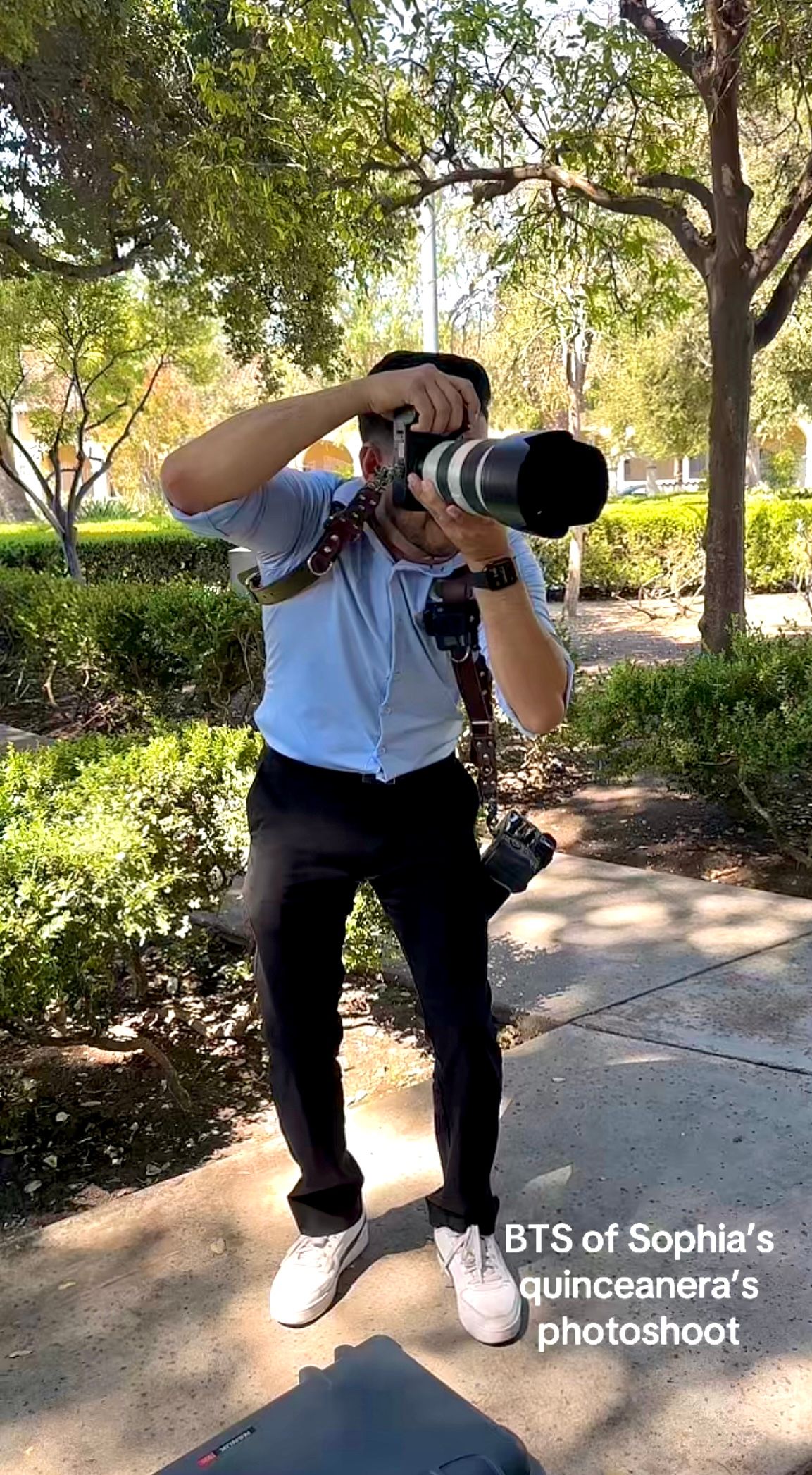 Behind-the-scenes series showing photographer crouching low with camera to capture creative angles in outdoor garden setting.