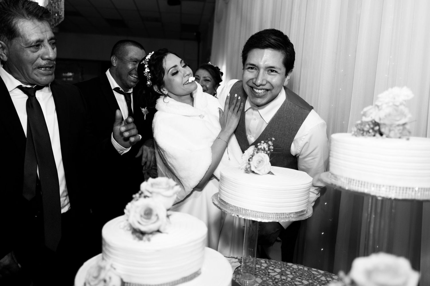 A collection of black and white wedding photos showing couples cutting their wedding cakes at different celebrations.