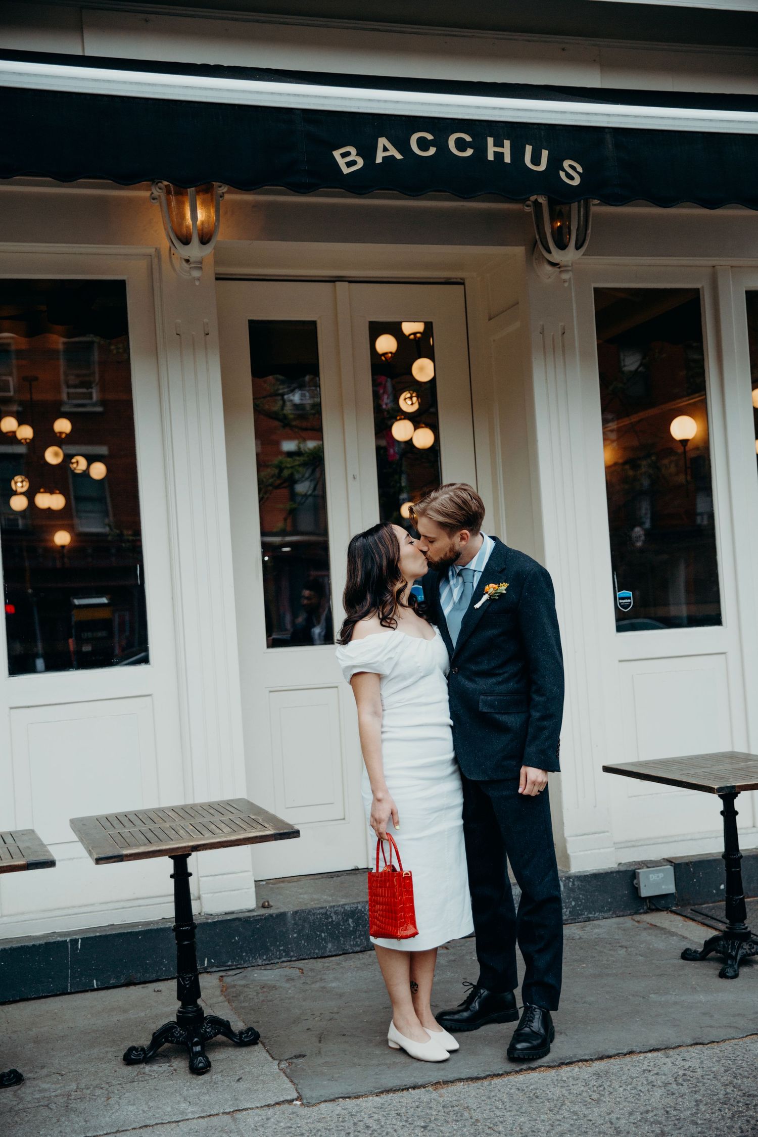 A romantic moment outside Bacchus restaurant with warm lighting and bistro tables.