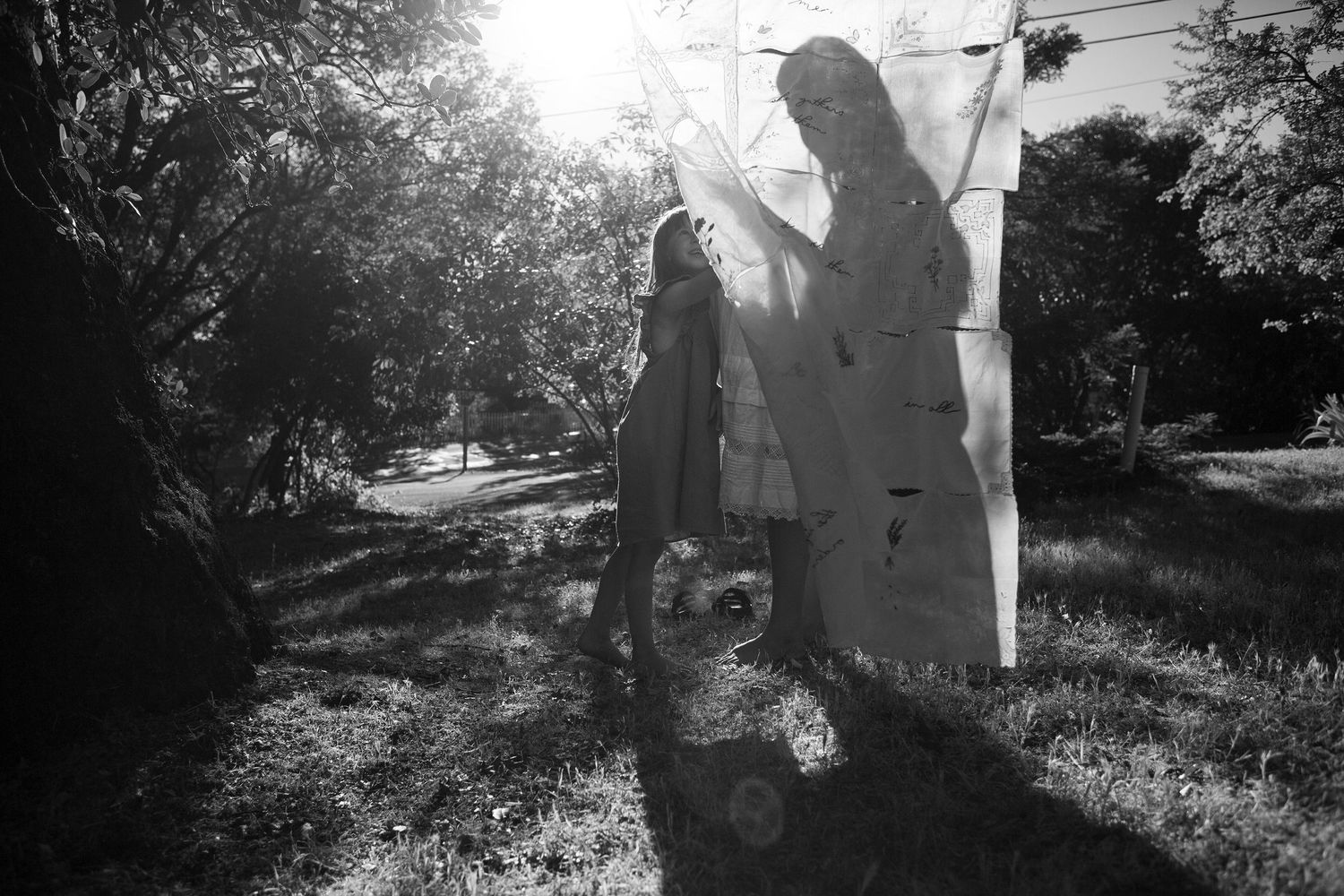 Silhouettes of two people walking together in a natural outdoor setting.