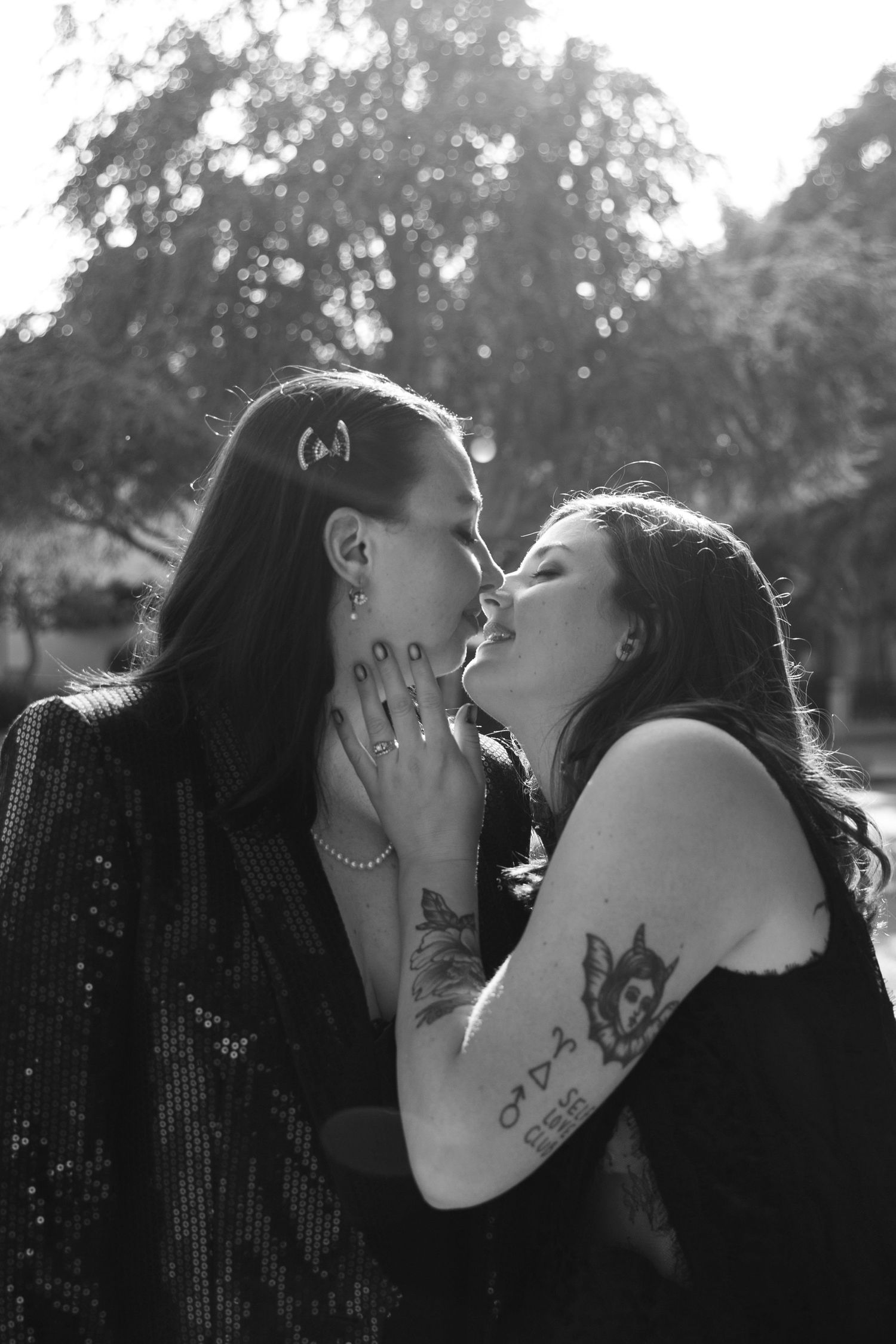 Black and white portraits showing intimate artistic moments between a couple with matching dark outfits.