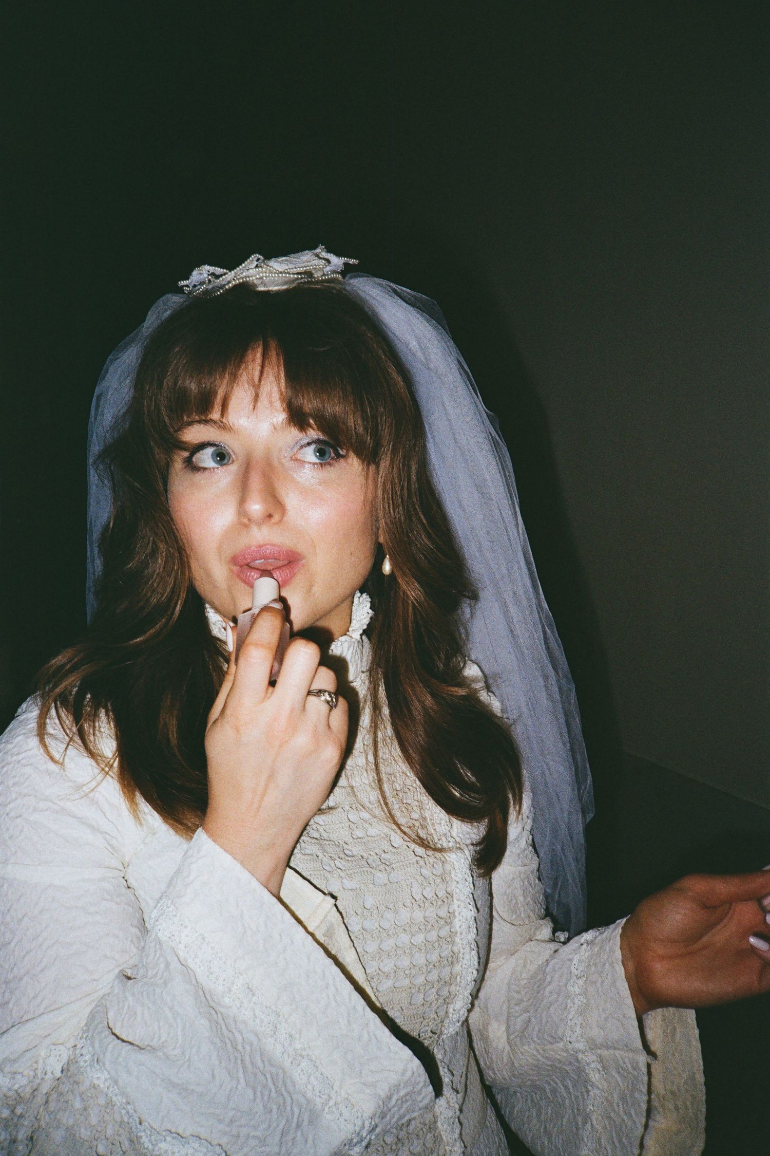 Close-up shots of bride wearing white veil at San Francisco City Hall.