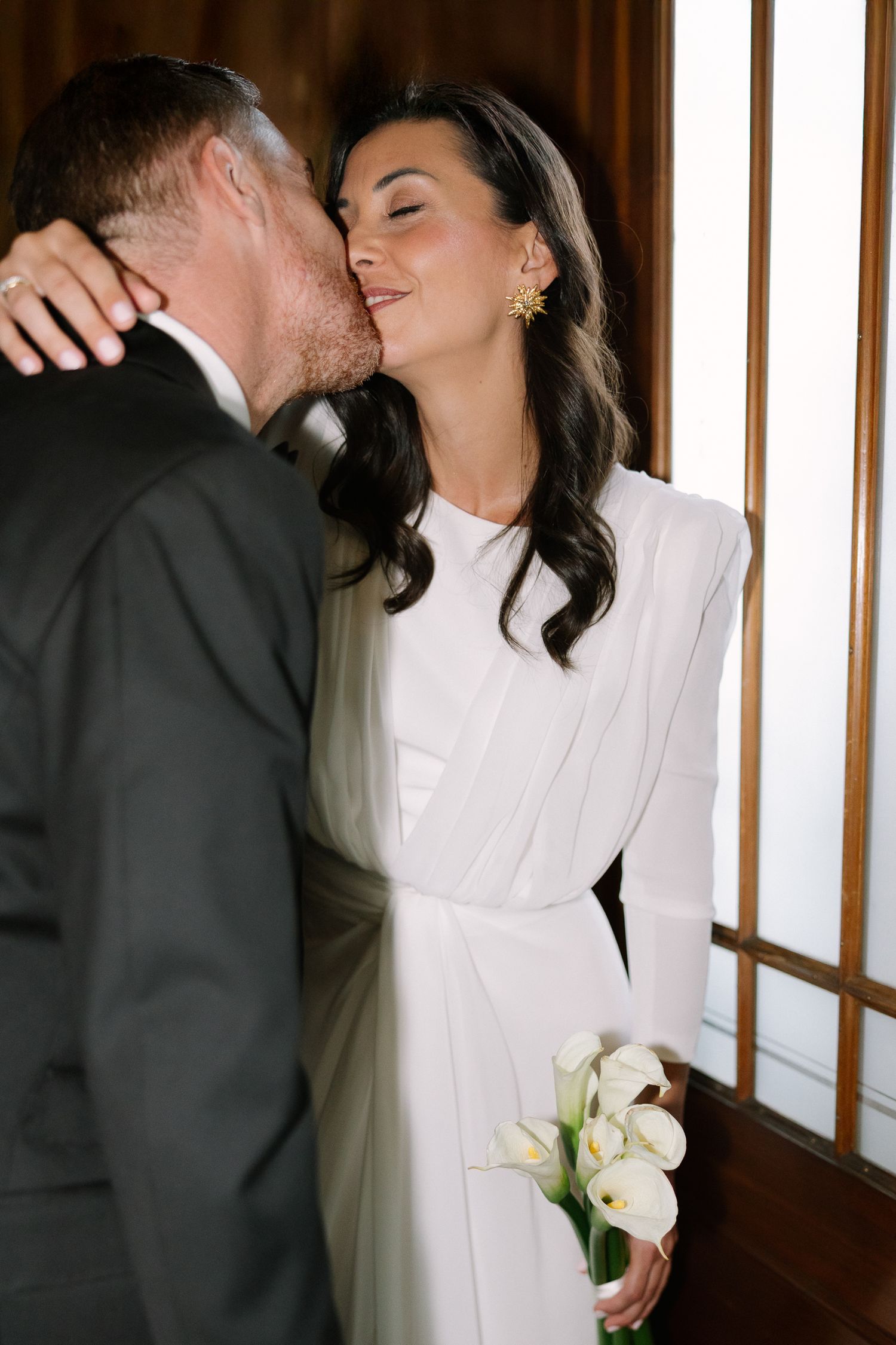 A romantic sequence of wedding photographs showing tender moments between newlyweds in a rustic wood-paneled setting.
