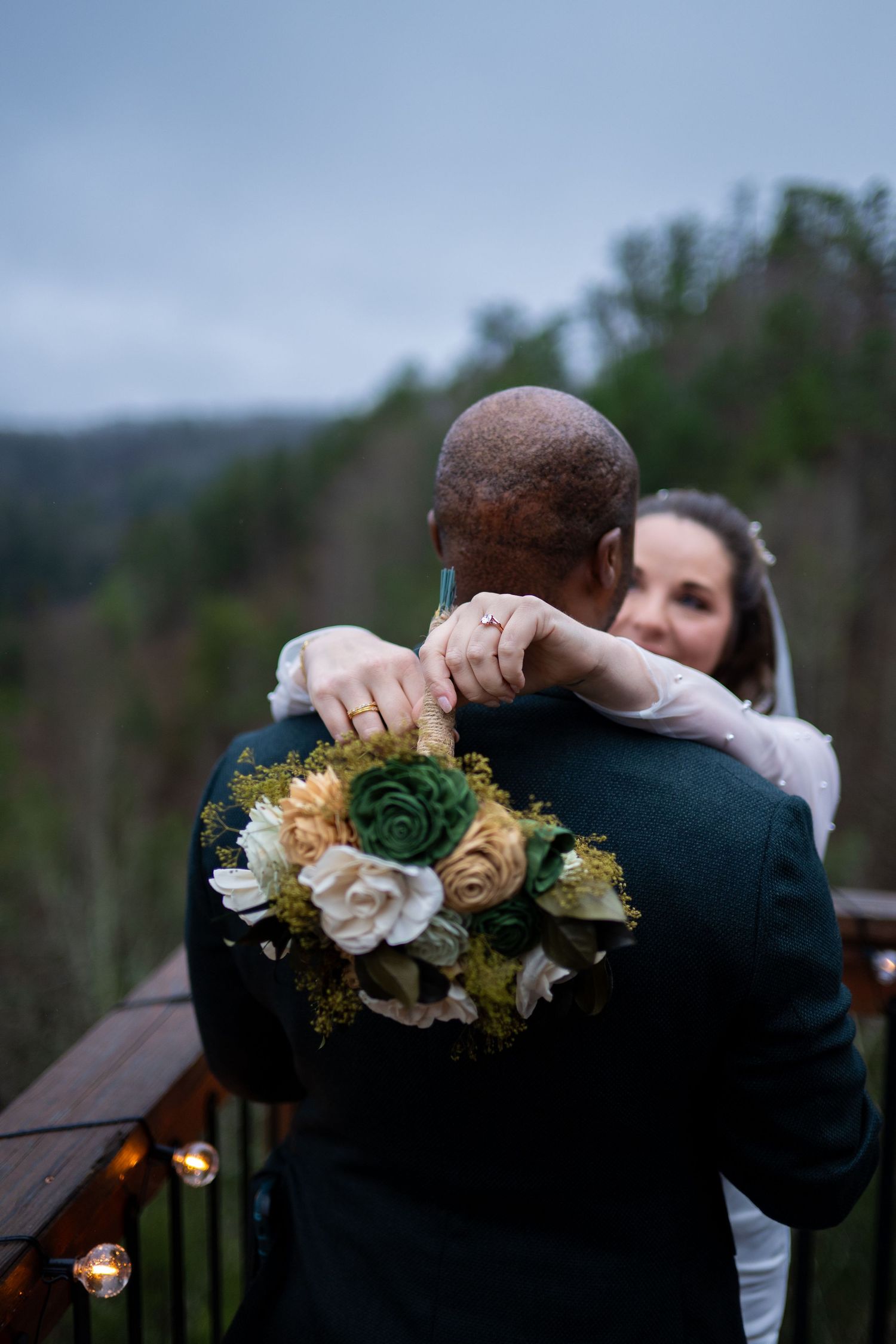 A romantic outdoor wedding scene shows a couple embracing against a natural backdrop with floral decorations.