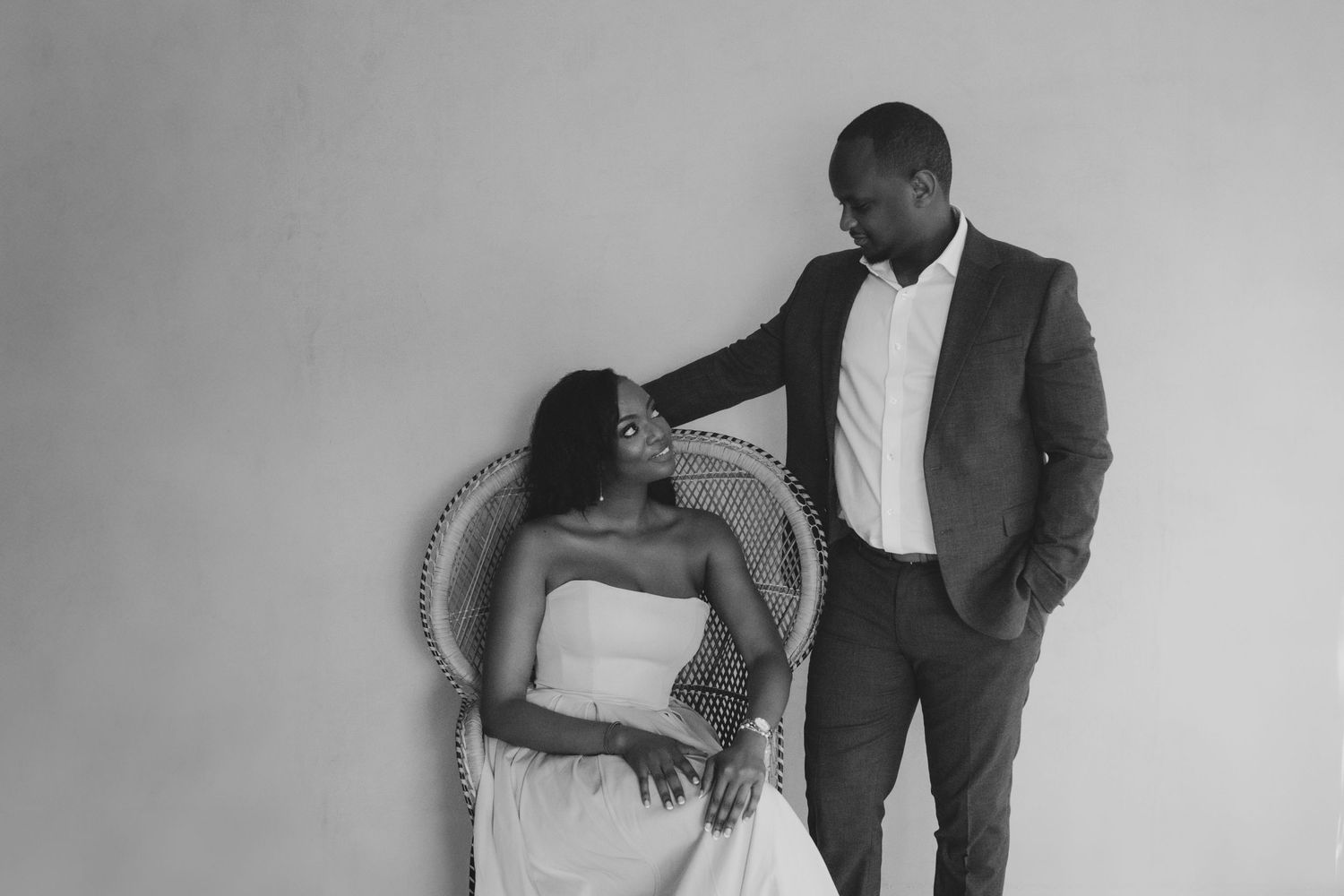 Black and white photo series showing intimate moments between a couple in formal attire during a romantic photoshoot.