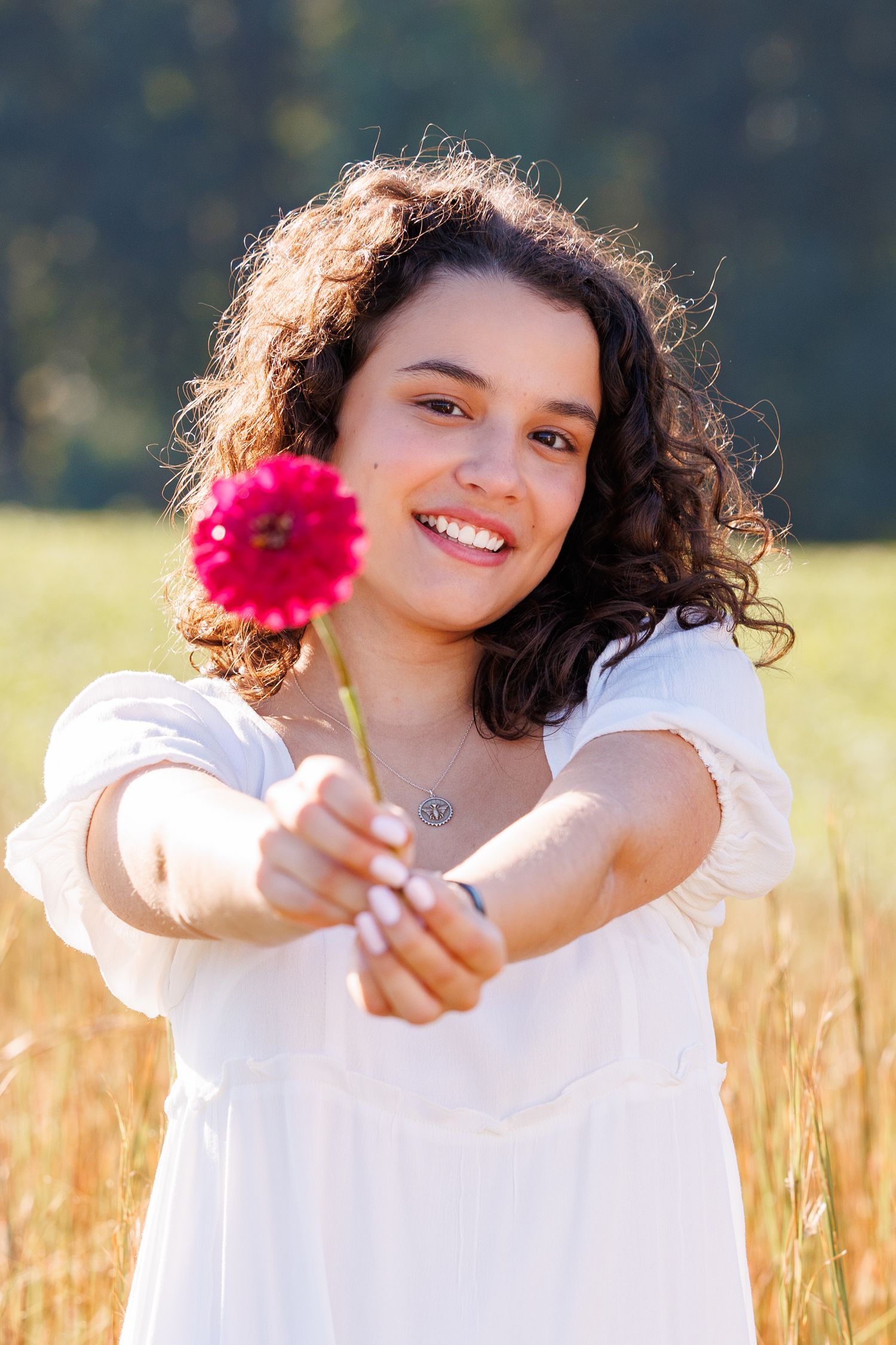 Senior Portrait North Carolina senior girl flowers dogwood farms Kernersville white dress portrait photography girl holding flower