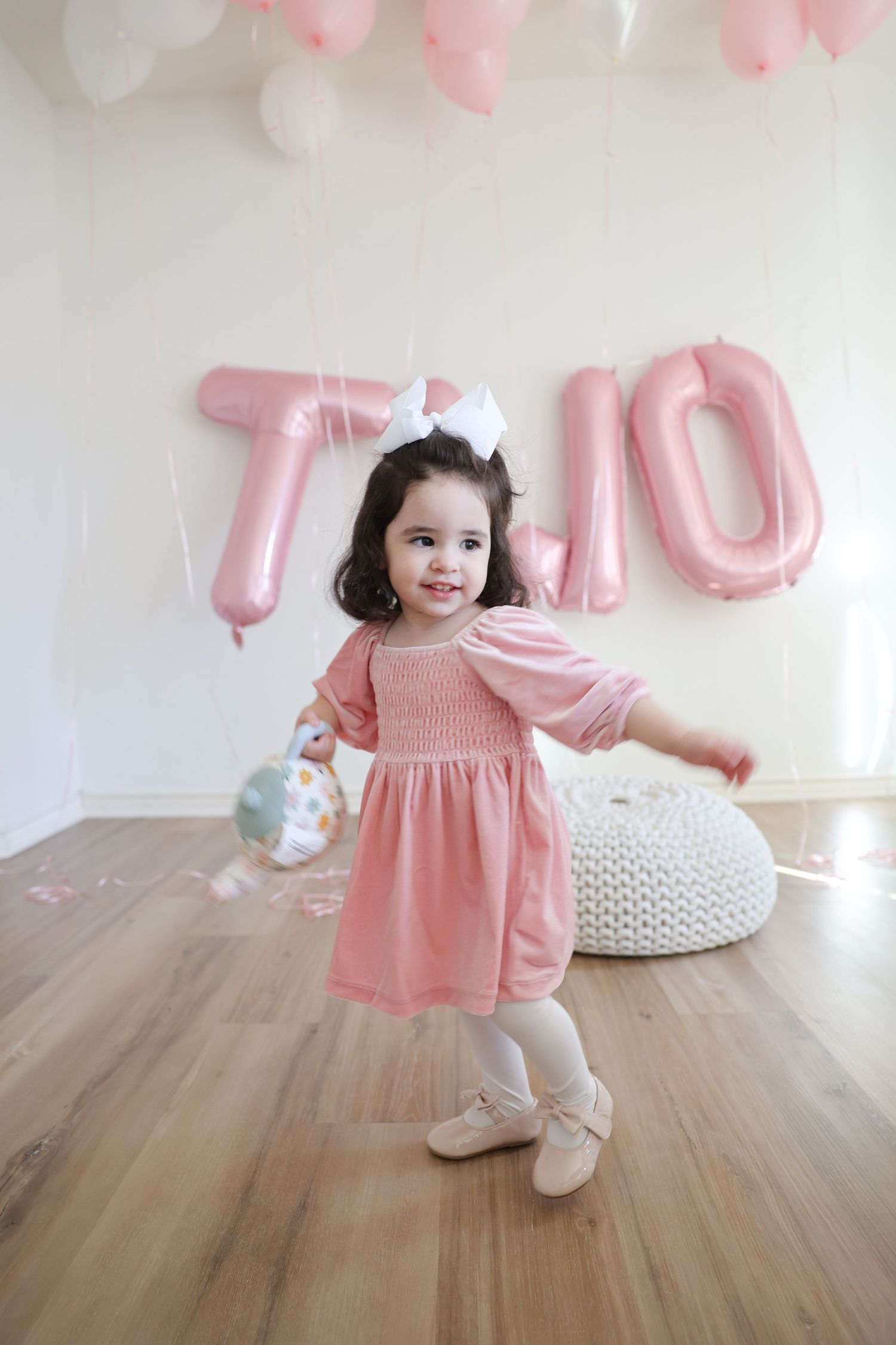 A joyful child celebrating their birthday with a tea party during a studio photoshoot in Austin, TX.