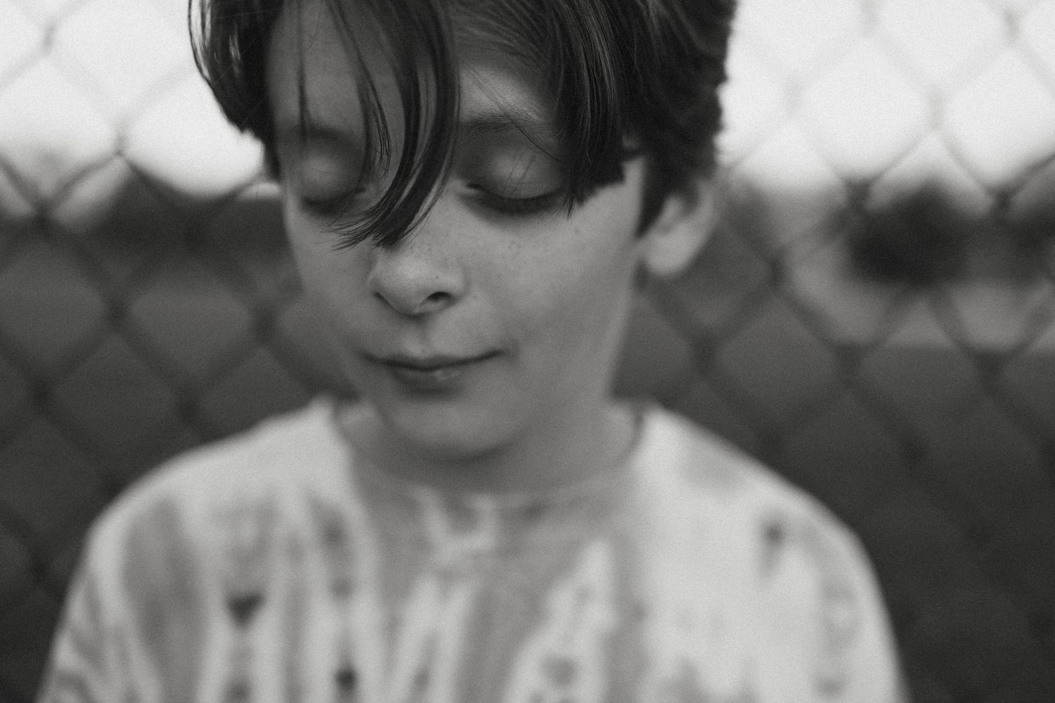 Black and white portrait of someone gazing upward in a contemplative pose.