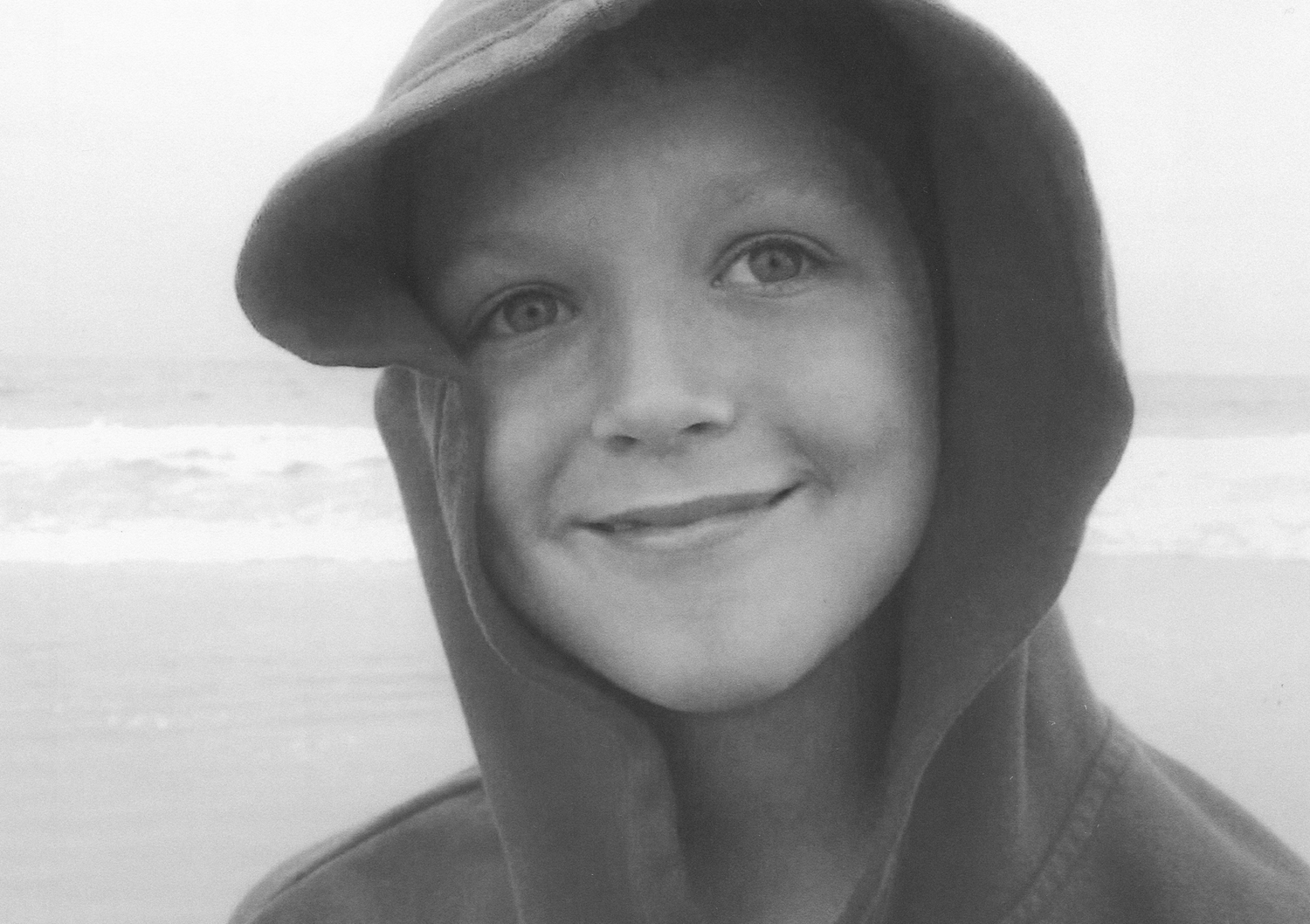 Series of black and white portraits showing different expressions in hooded attire.