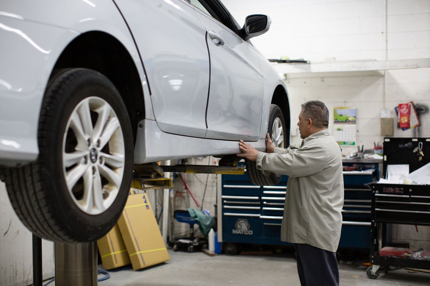 Auto service technicians working on vehicle maintenance in modern repair facility.