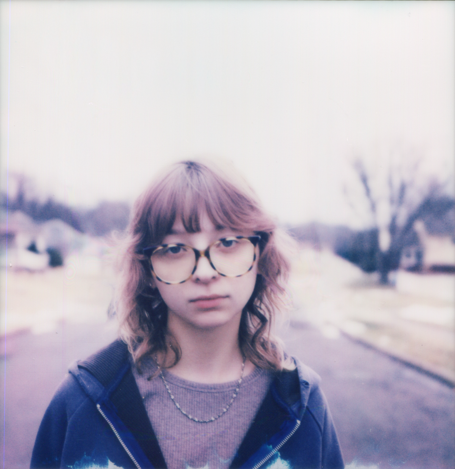 A series of dreamy vintage-style portraits showing someone wearing sunglasses in a soft purple-tinted outdoor setting.
