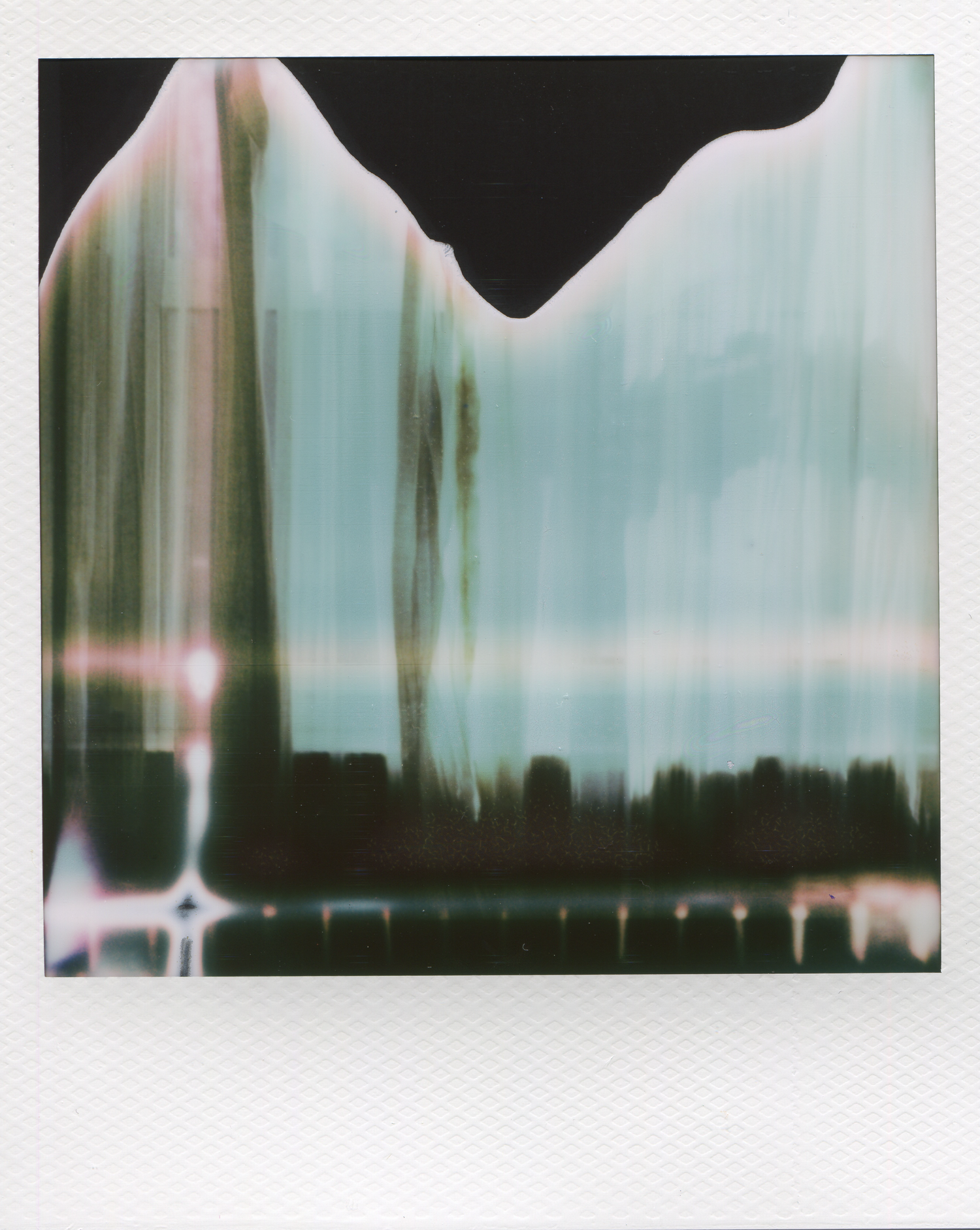 Abstract Polaroid photo with light leaks and color distortion creating an artistic, experimental film effect.