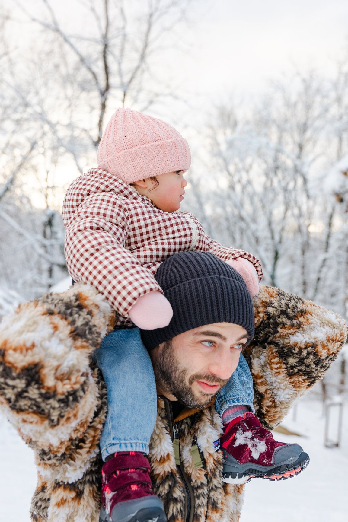 Playful winter scene with people in warm clothing enjoying snowy weather.