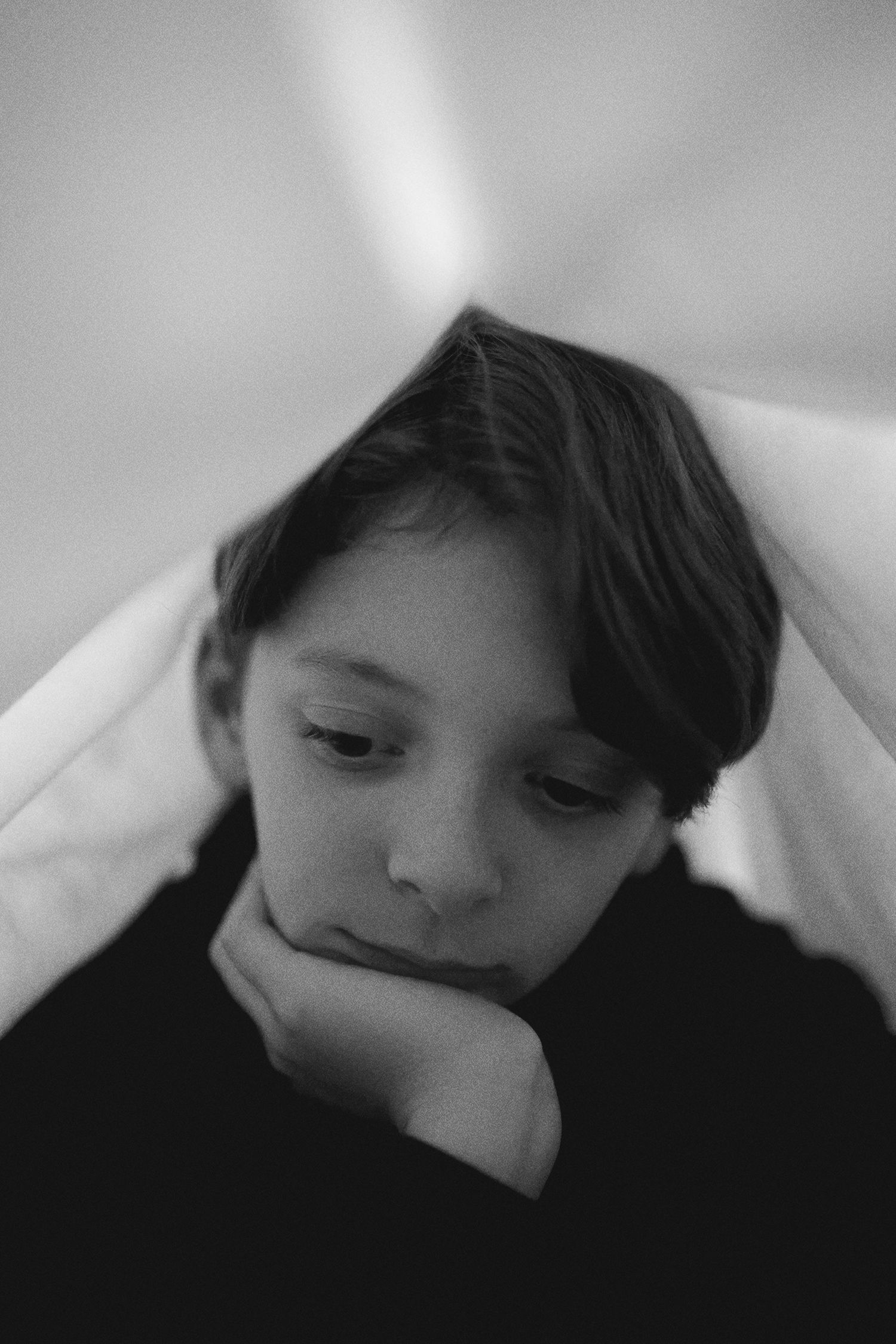 Artistic black and white portrait series showing quiet introspective moments.
