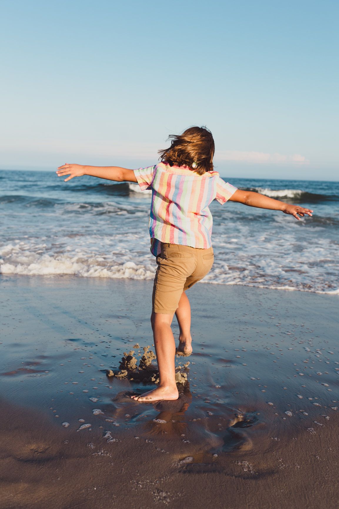 Boy running on beach documentary family kids photography Ocean City, NJ