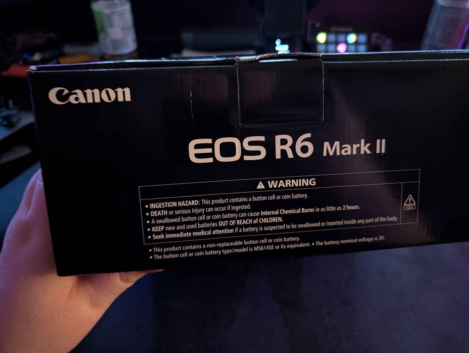 Canon EOS R6 Mark II camera box with warning label, shown against a dark background.