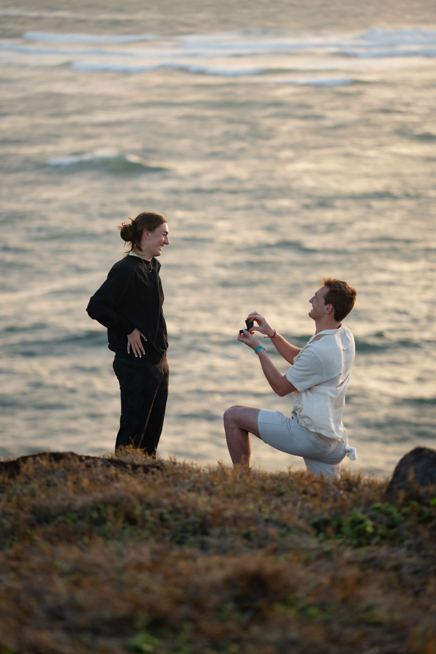 St Lucia proposal captured by wedding photographer-videographer, showing emotional surprise engagement moment between couple at sunrise
