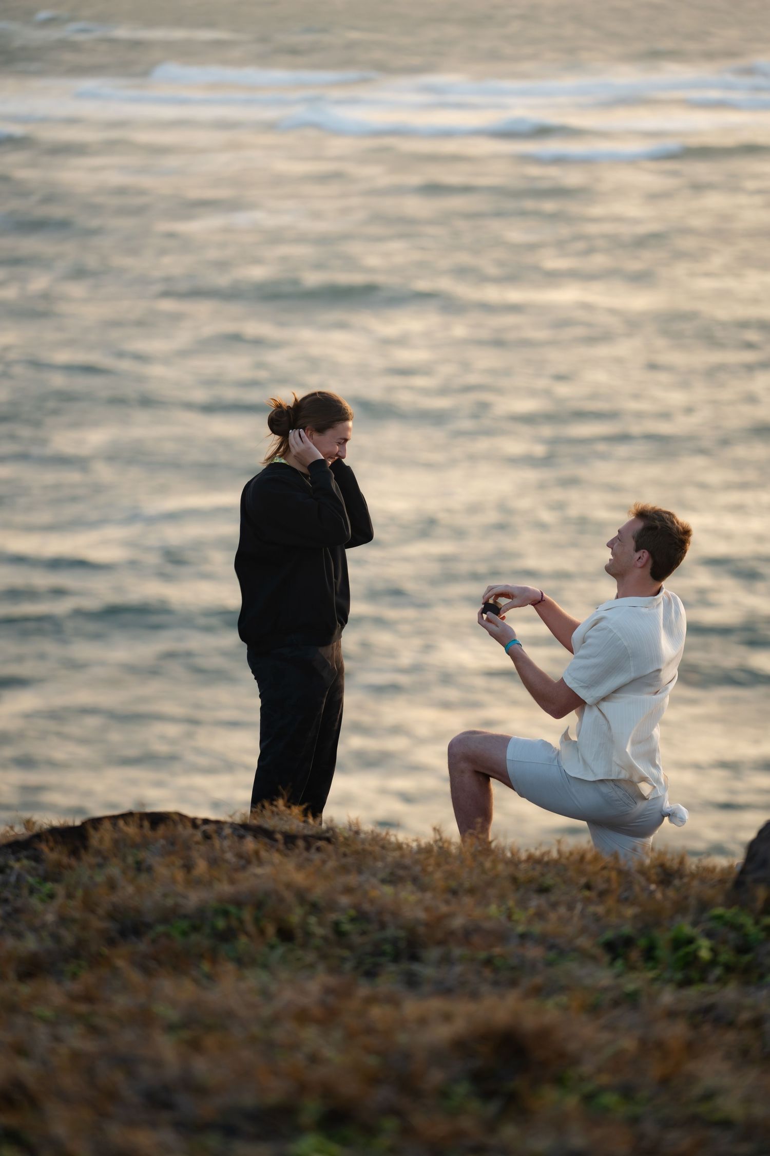 St Lucia proposal captured by wedding photographer-videographer, showing emotional surprise engagement moment between couple at sunrise