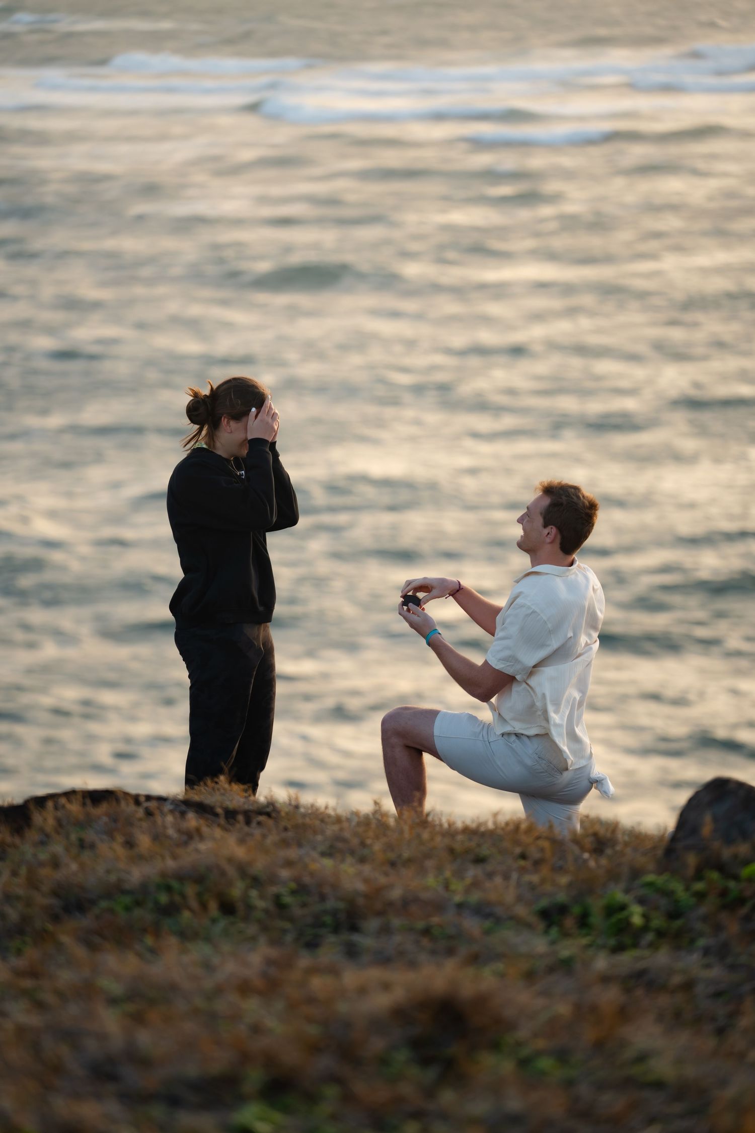 St Lucia proposal captured by wedding photographer-videographer, showing emotional surprise engagement moment between couple at sunrise
