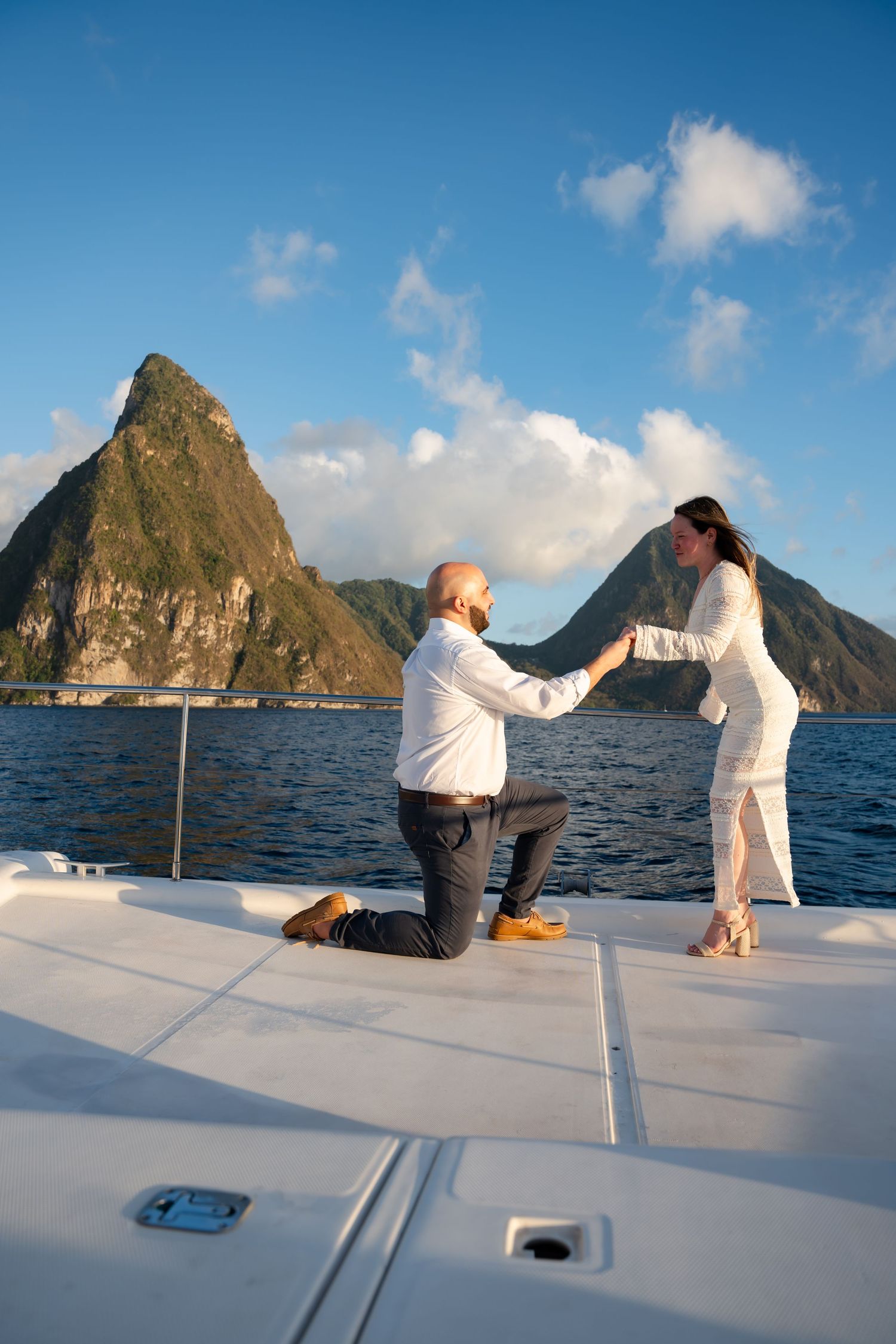 St Lucia proposal captured by wedding photographer-videographer, showing emotional surprise engagement moment between couple at sunset