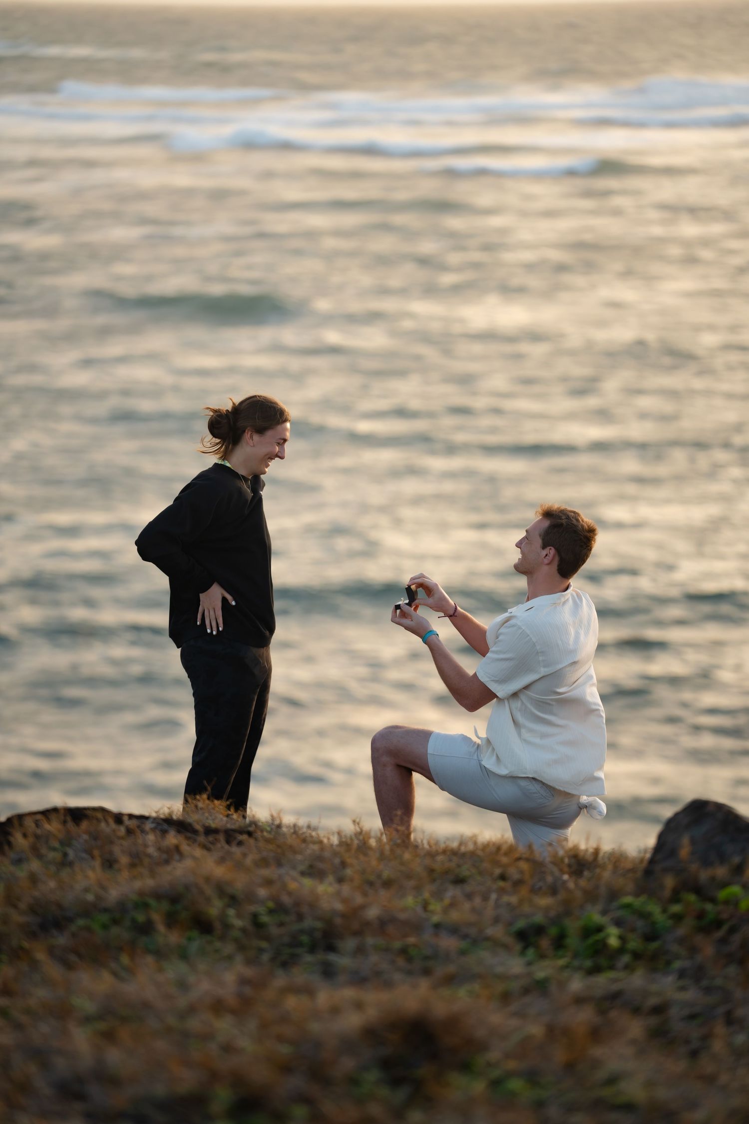 St Lucia proposal captured by wedding photographer-videographer, showing emotional surprise engagement moment between couple at sunrise