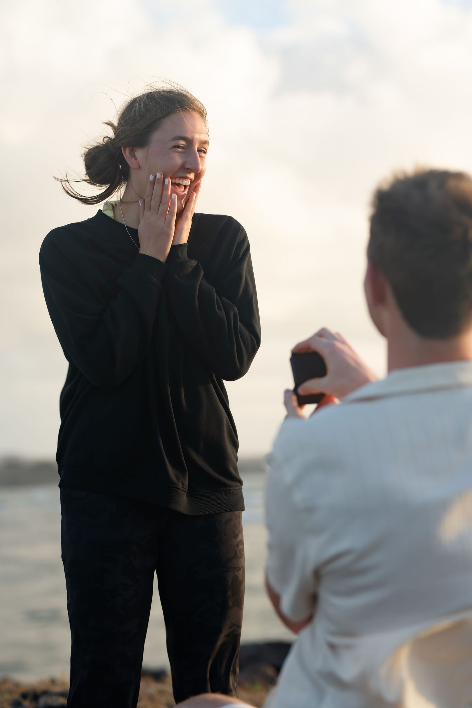 St Lucia proposal captured by wedding photographer-videographer, showing emotional surprise engagement moment between couple at sunrise
