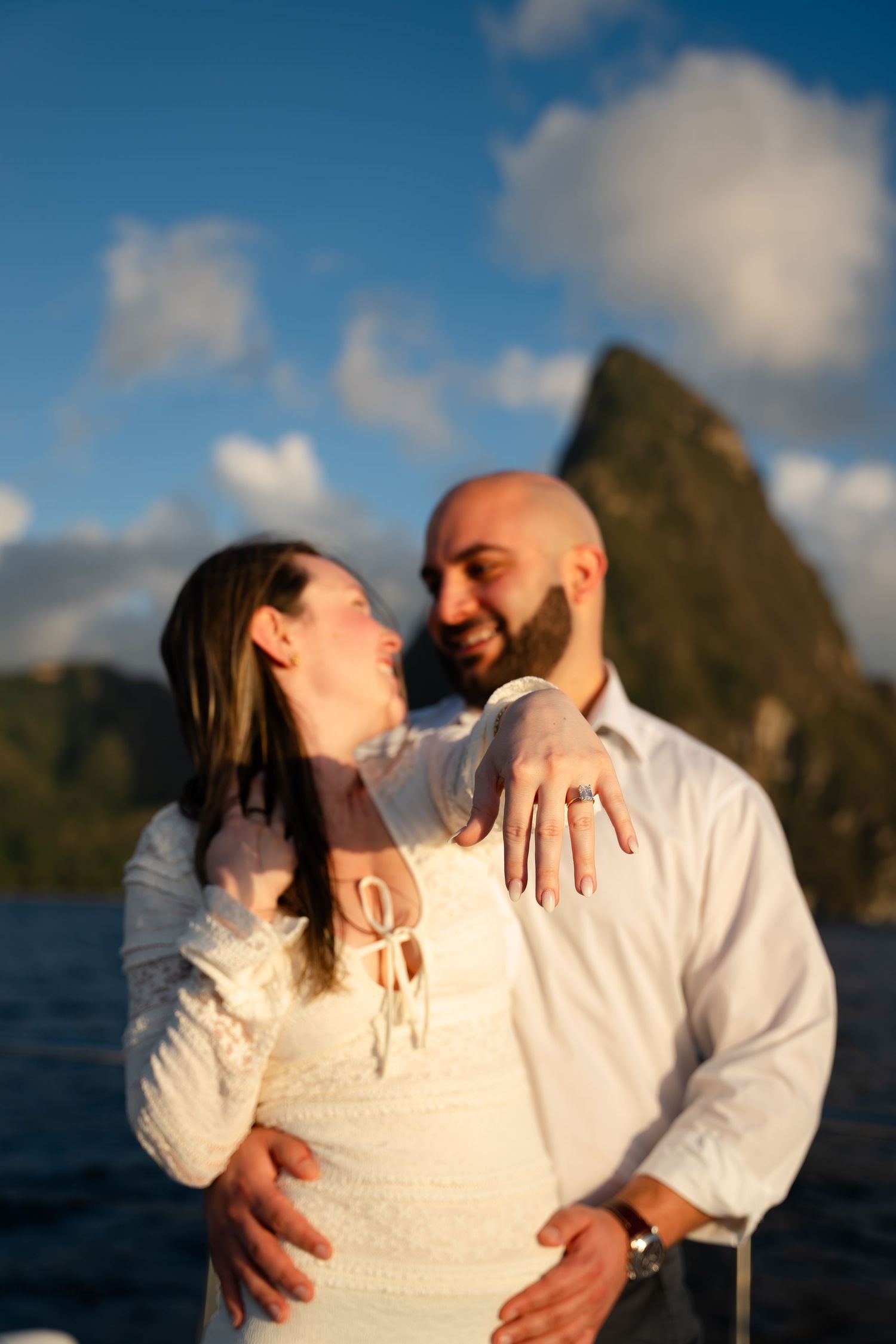 St Lucia proposal captured by wedding photographer-videographer, showing emotional surprise engagement moment between couple at sunset
