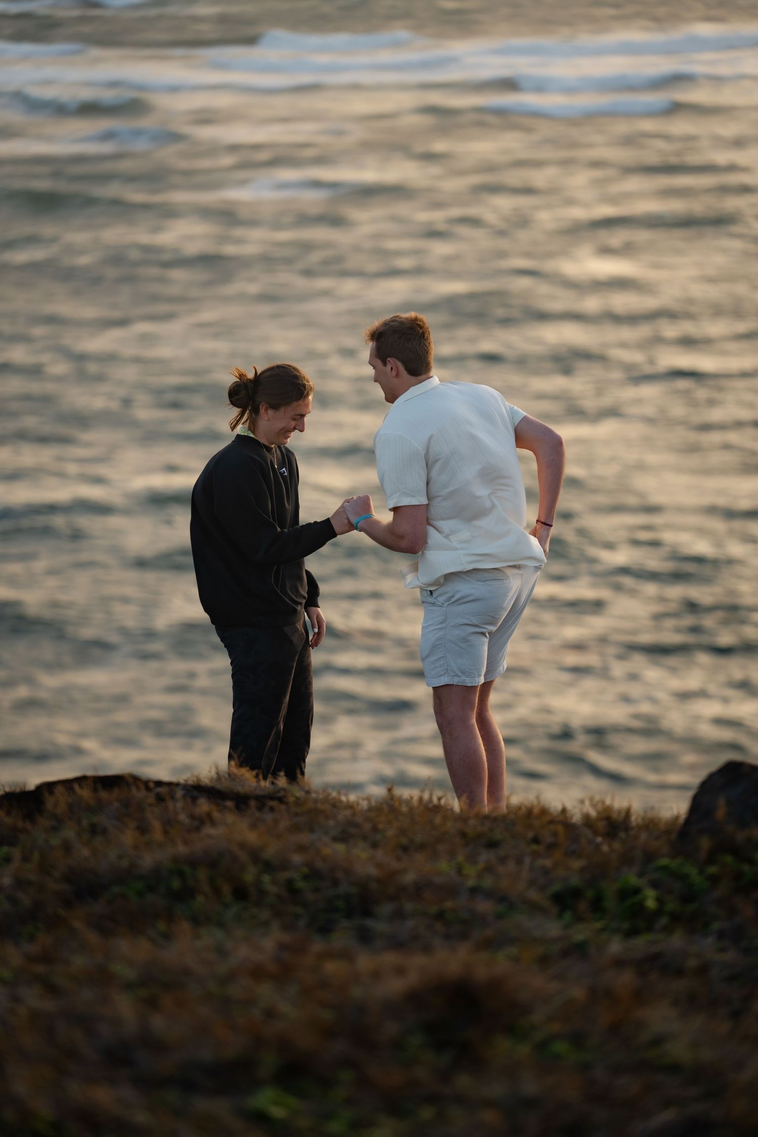 St Lucia proposal captured by wedding photographer-videographer, showing emotional surprise engagement moment between couple at sunrise