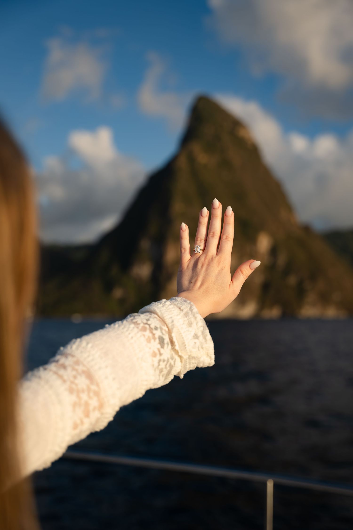 St Lucia proposal captured by wedding photographer-videographer, showing emotional surprise engagement moment between couple at sunset