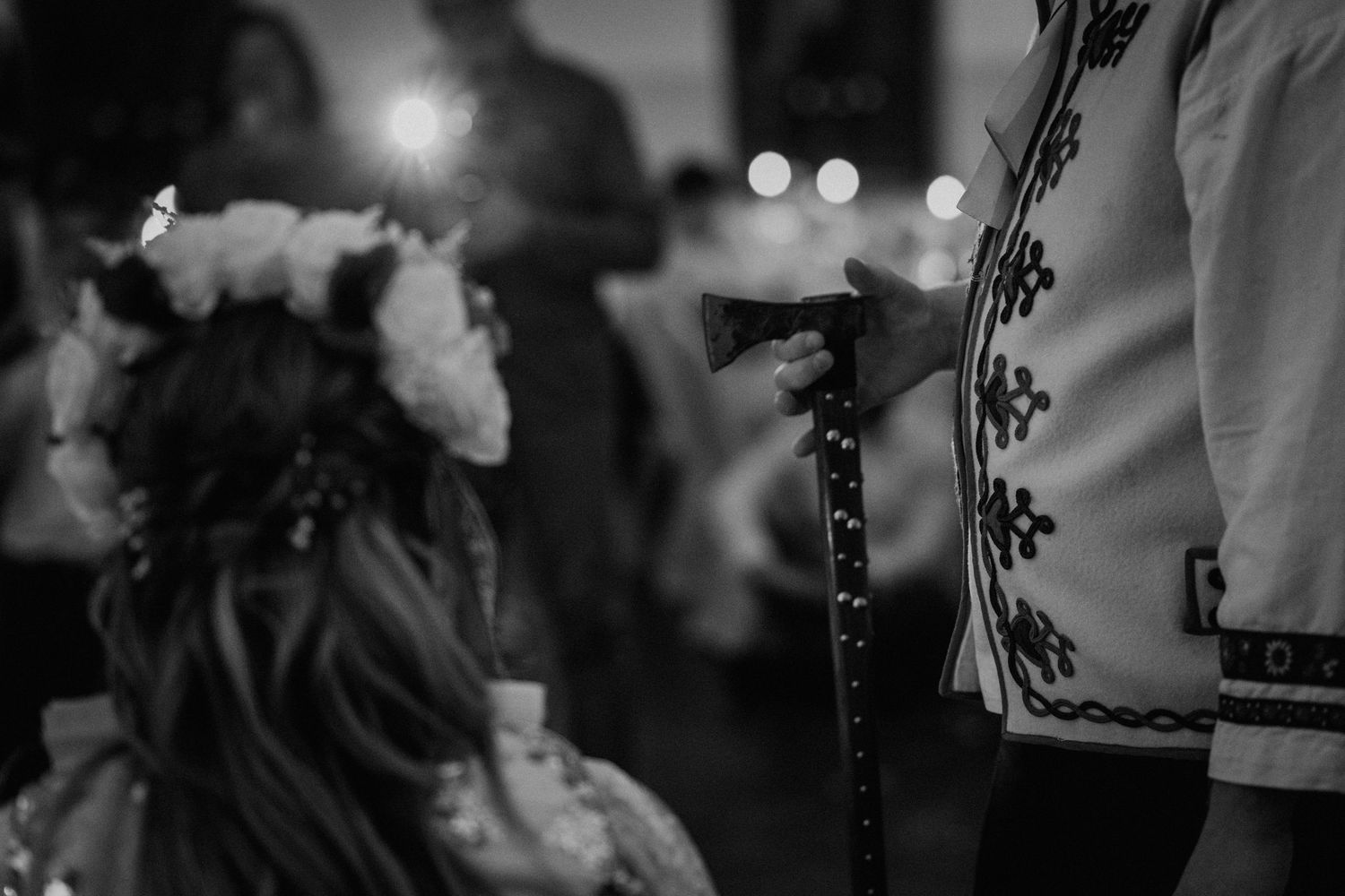 Black and white photo of girl with flower crown at traditional folk ceremony.