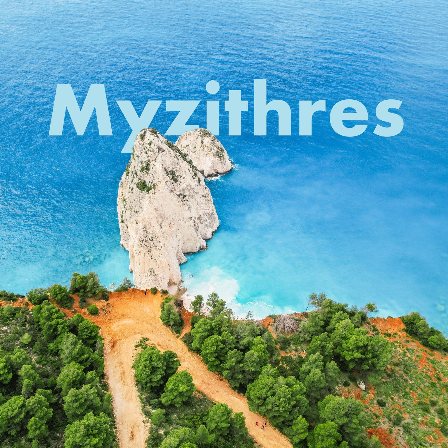 Aerial view of Myzithres rock formation rising from the vivid turquoise waters of the Greek coast.