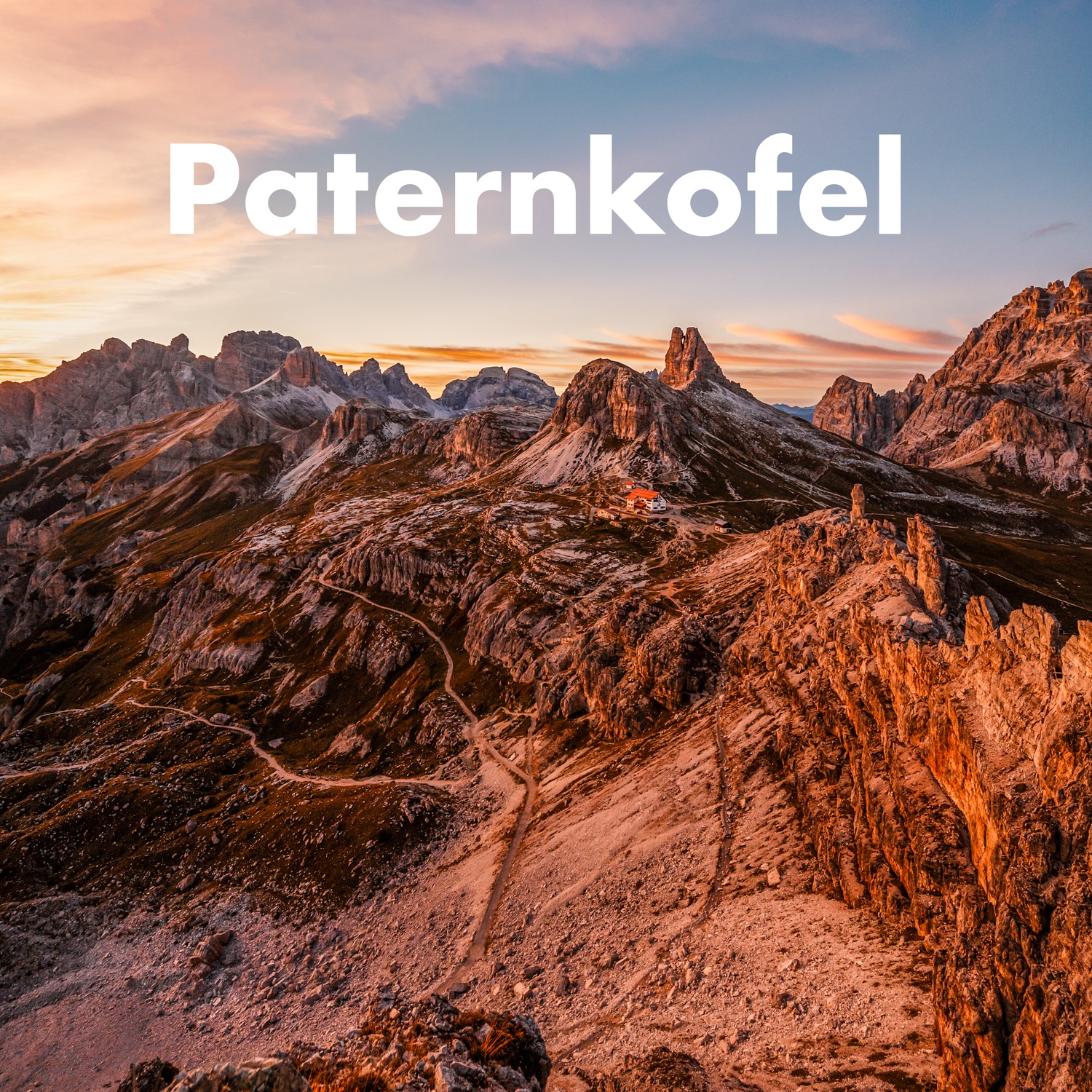 Dramatic sunset over the rocky Paternkofel mountain peak in the Dolomites of Italy.