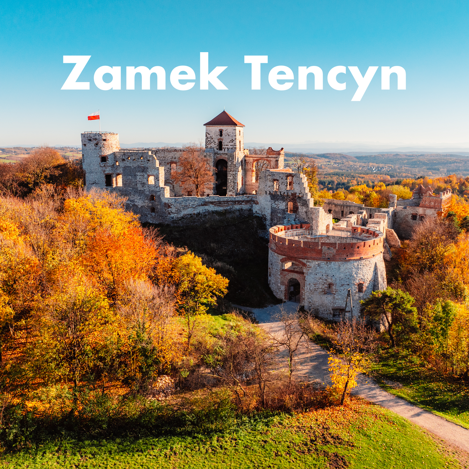 Ruins of medieval Tencyn Castle surrounded by colorful autumn foliage in Poland.