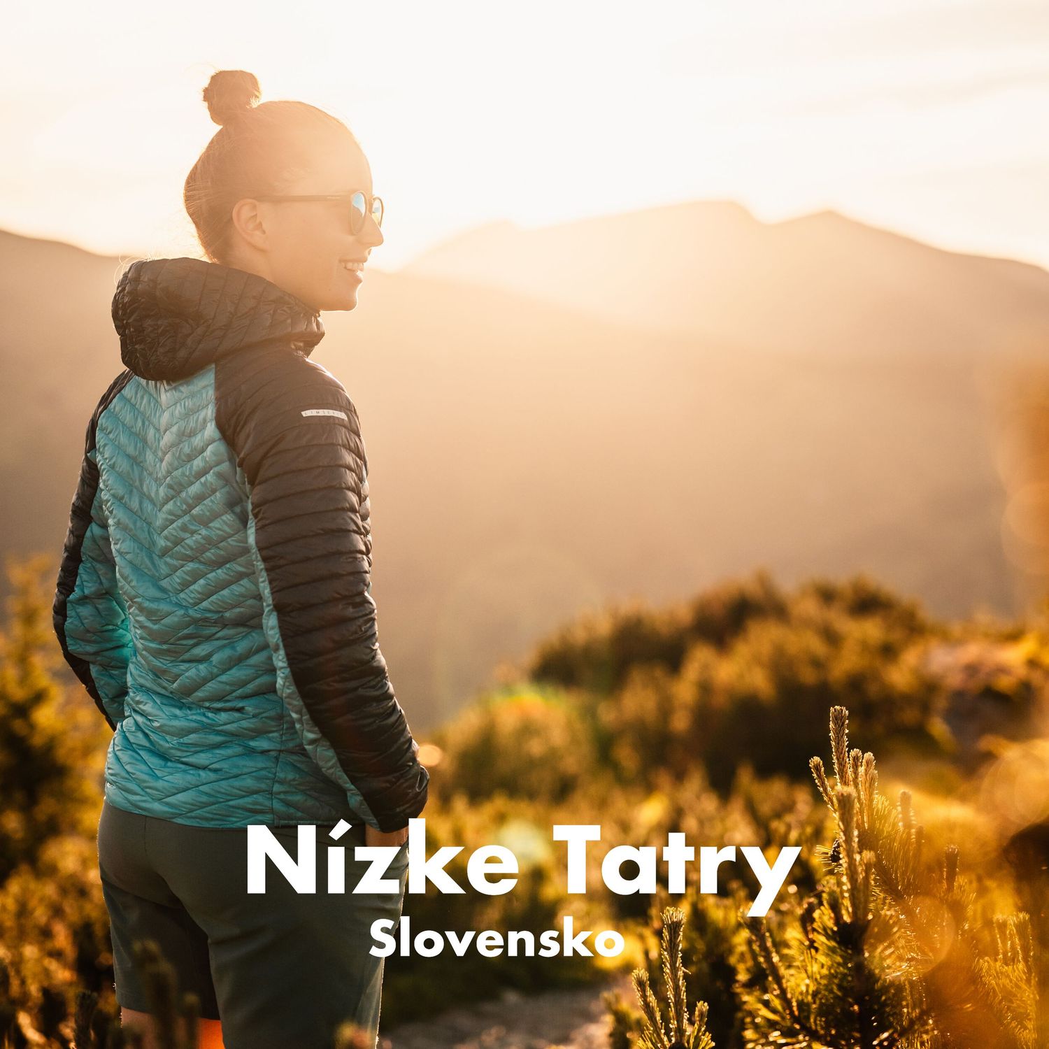 Hiker in teal jacket admires golden sunrise over mountain peaks in Nizke Tatry, Slovakia.