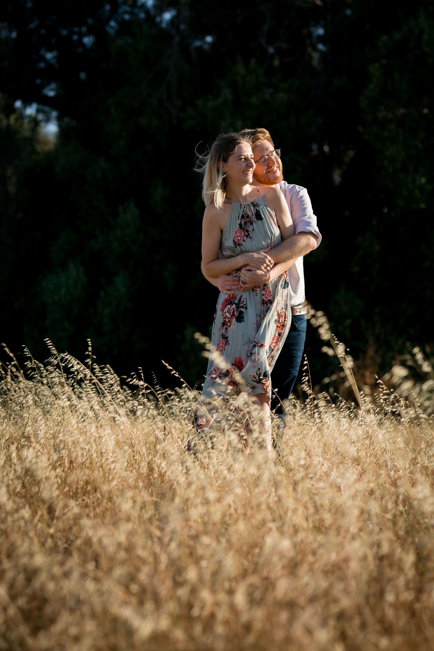 A romantic scene in tall grass with sunlight creating a magical glow.